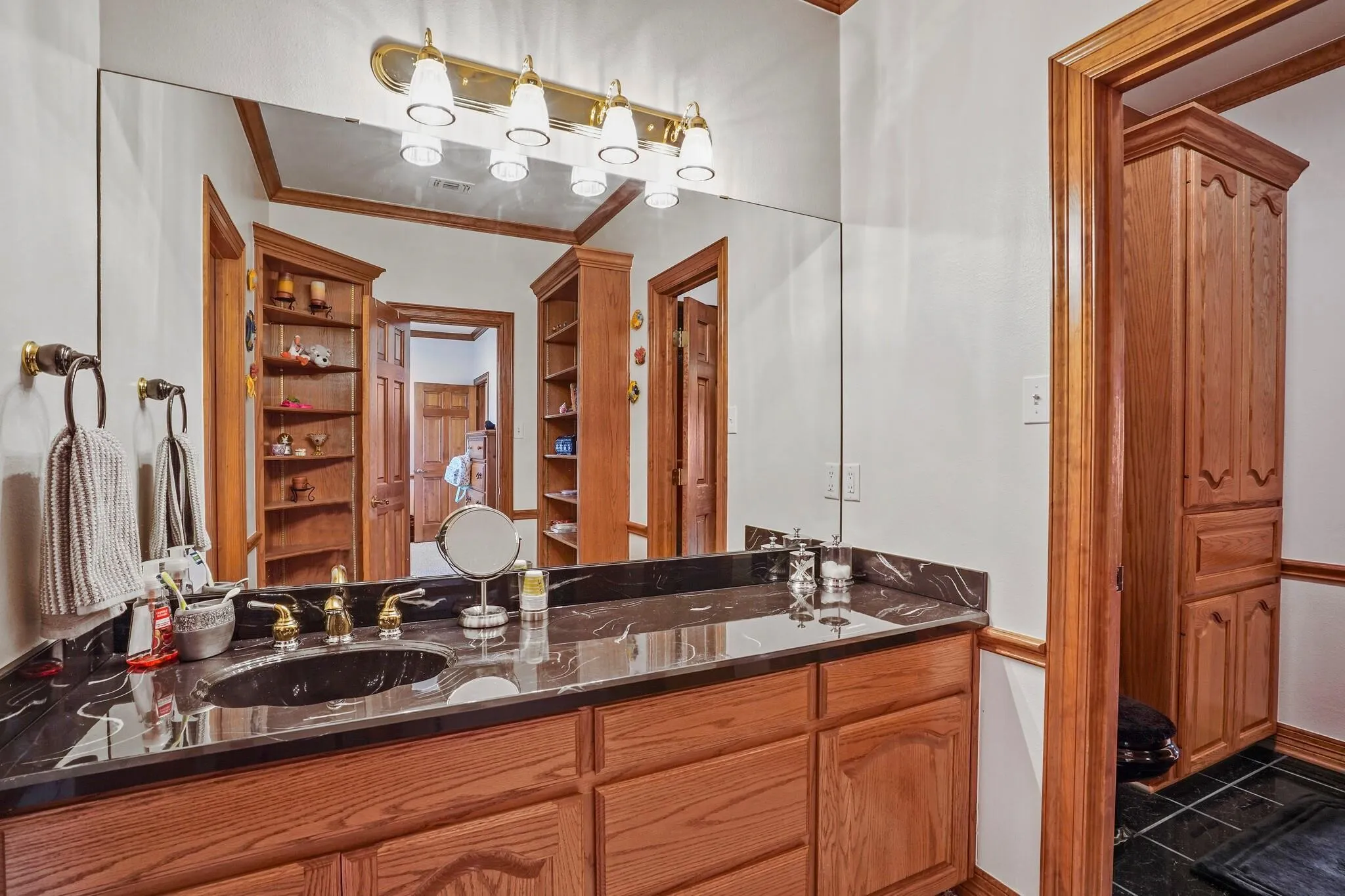 Bathroom with vanity and crown molding