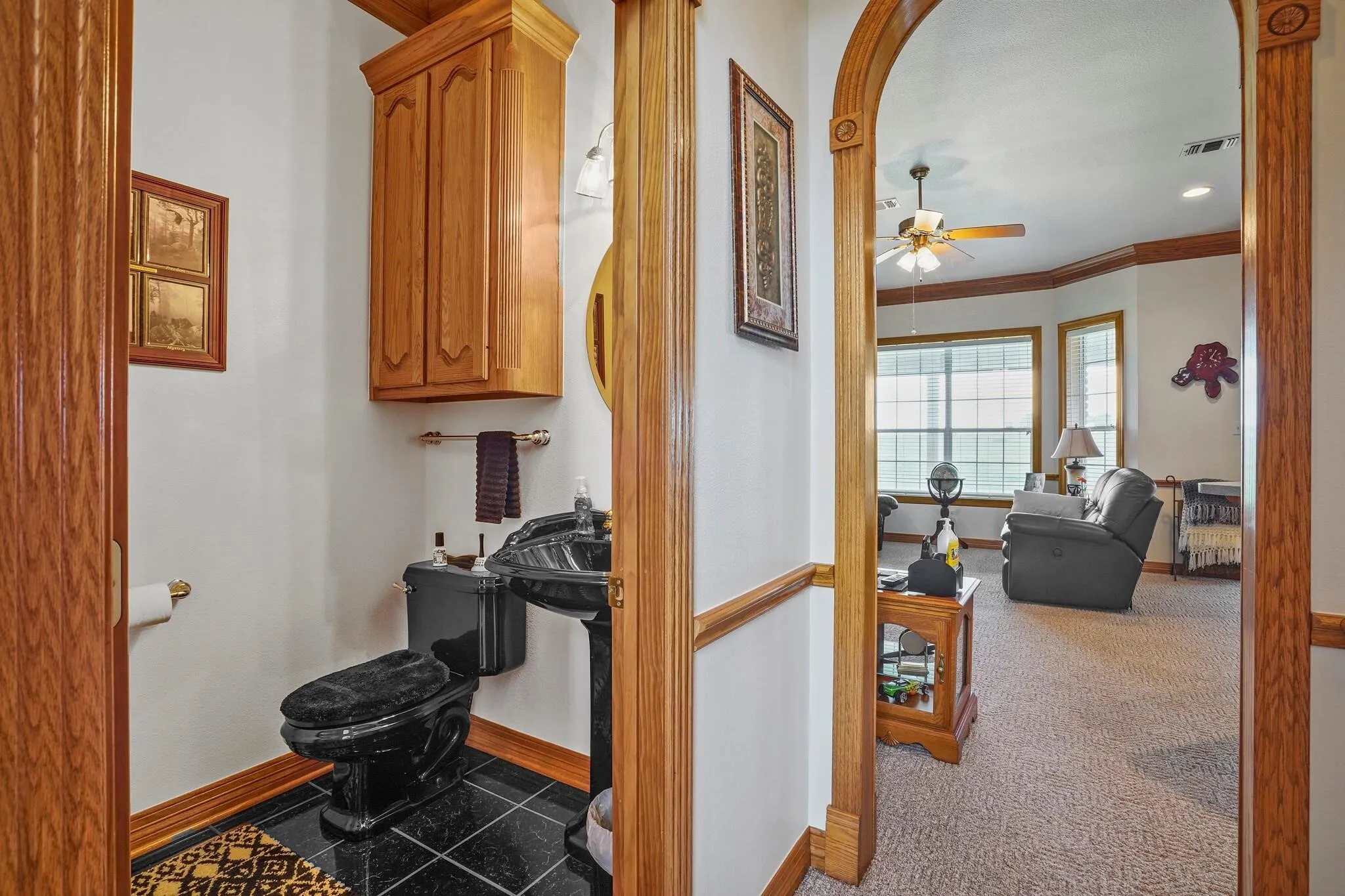 Hallway with carpet flooring and crown molding