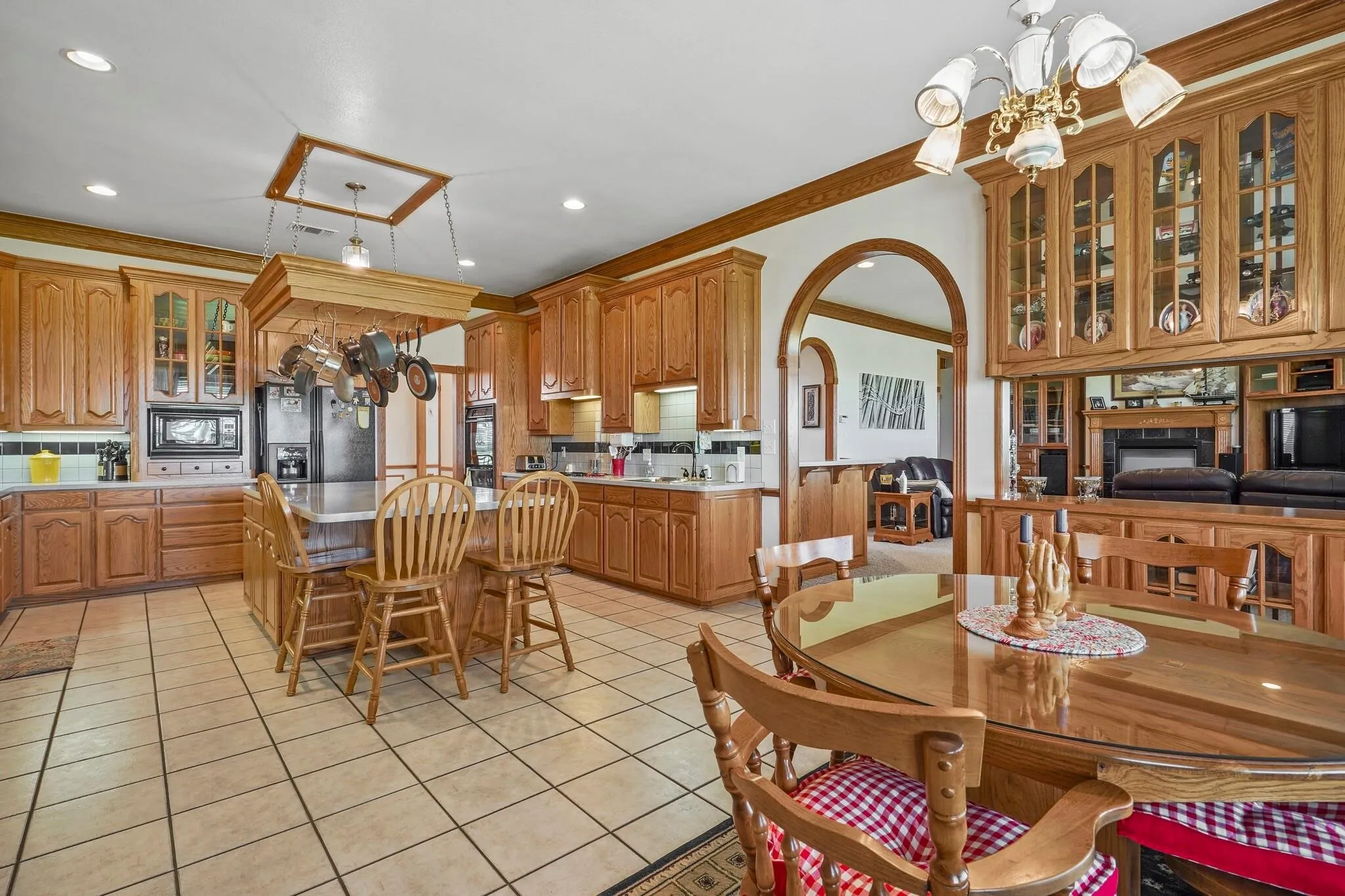 Tiled dining area featuring an inviting chandelier and ornamental molding