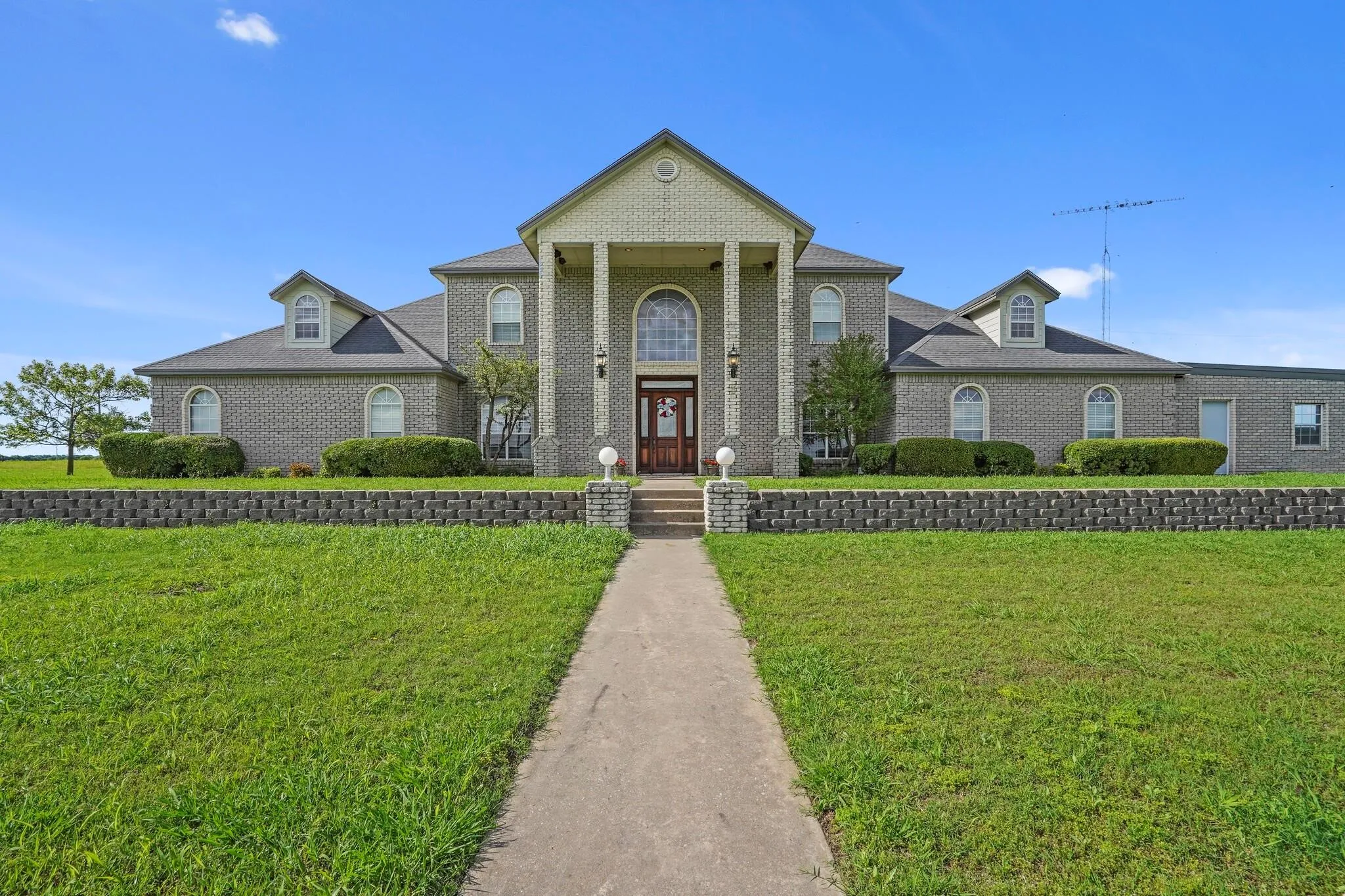 Neoclassical / greek revival house with a front lawn