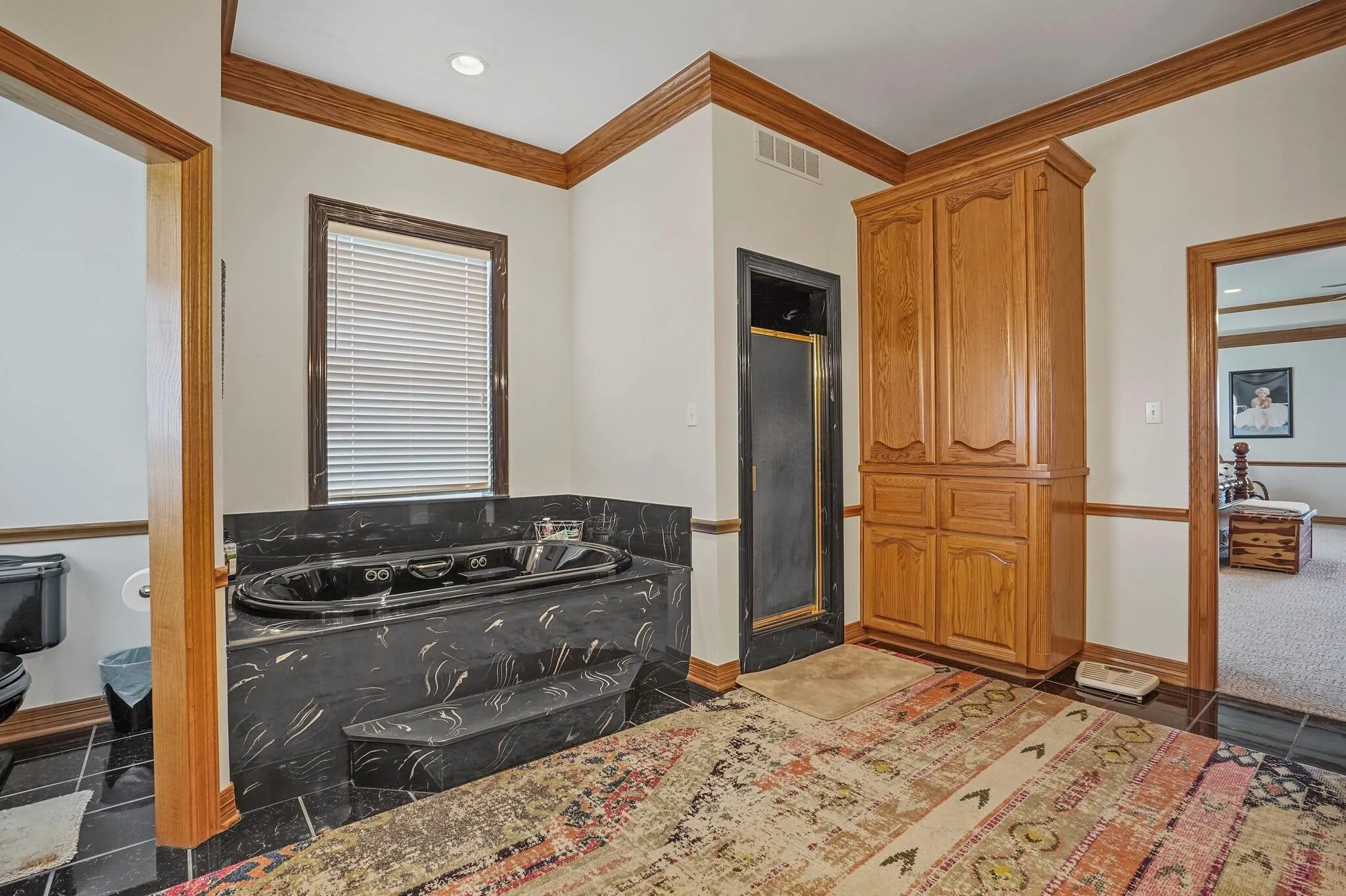 Bathroom with separate shower and tub, toilet, and crown molding