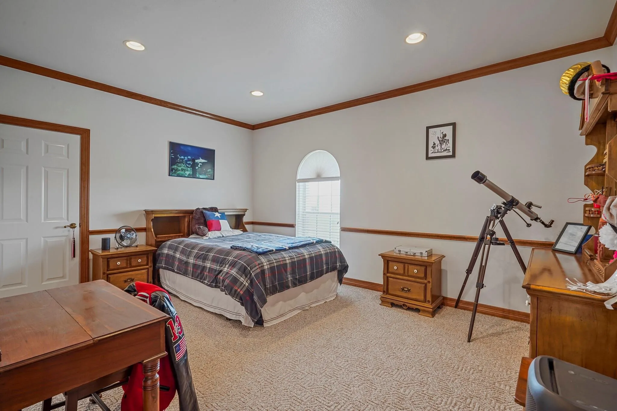 Carpeted bedroom with ornamental molding