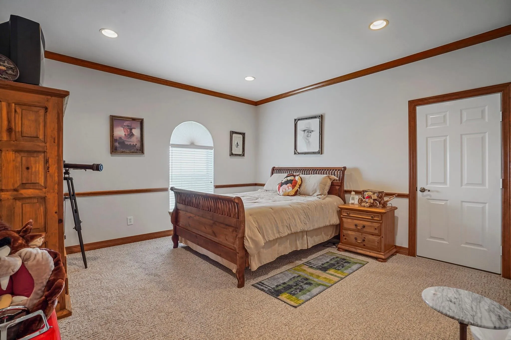 Carpeted bedroom with ornamental molding