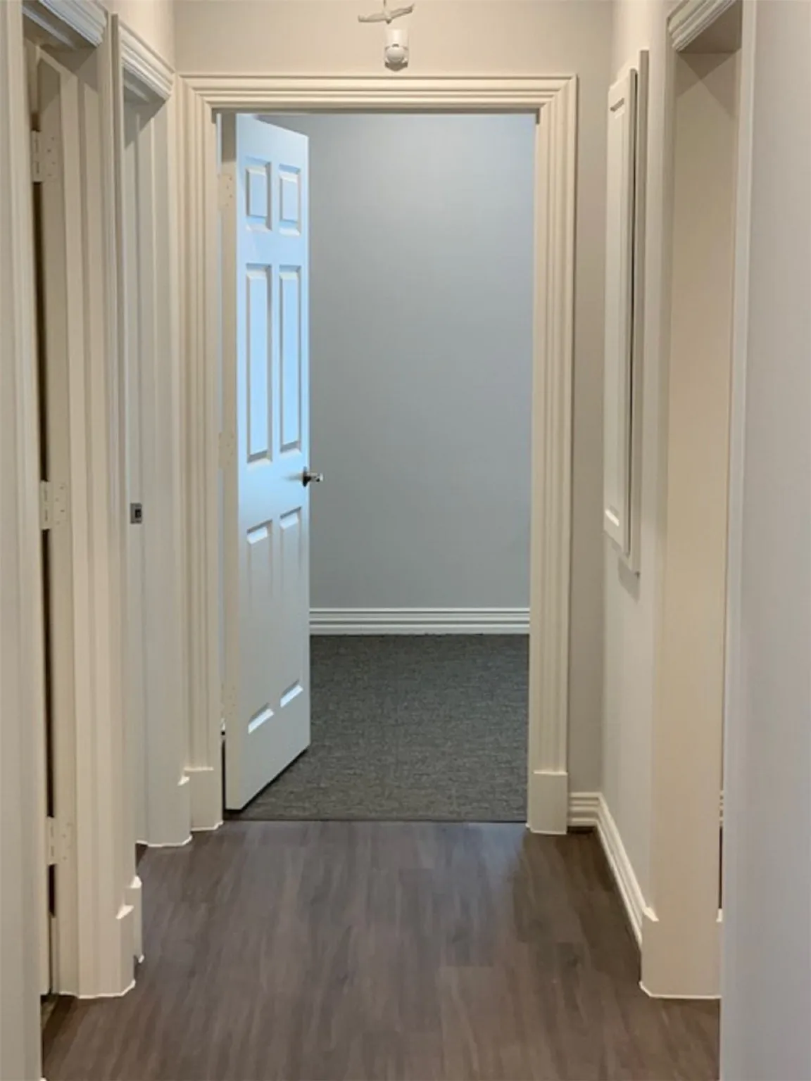 Hallway with dark wood-type flooring