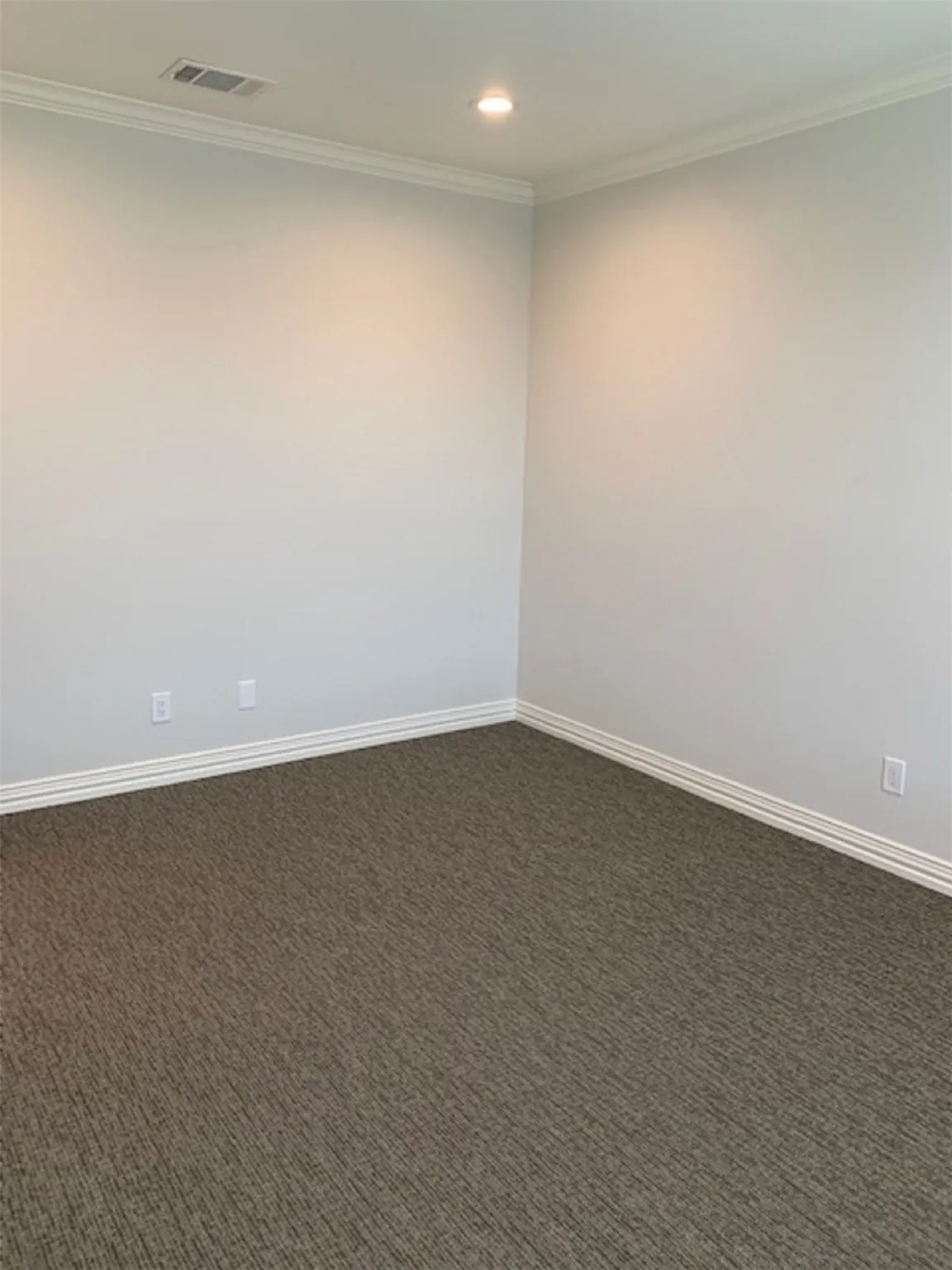 Carpeted empty room with crown molding