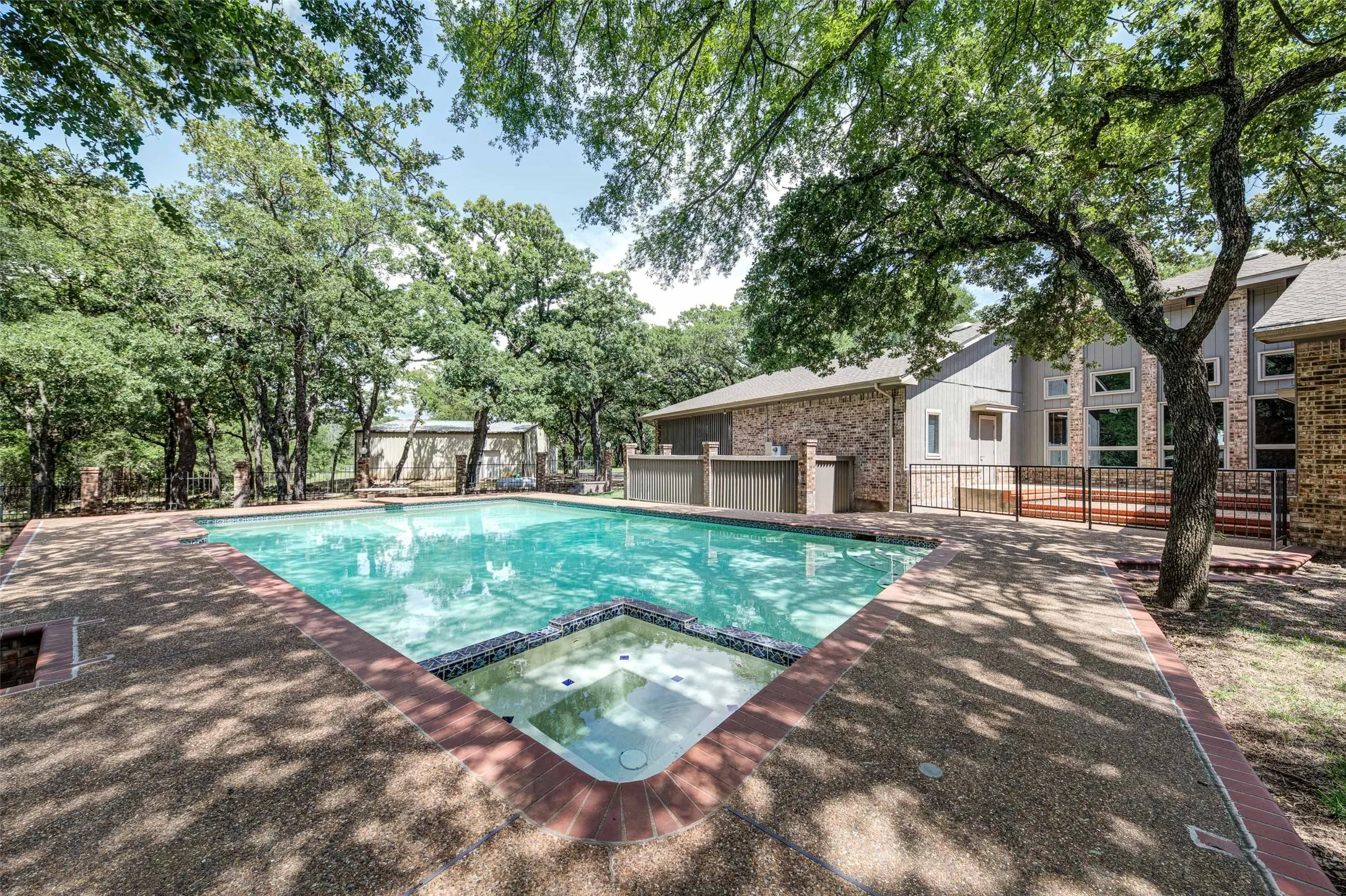 View of swimming pool with a pool with connected hot tub