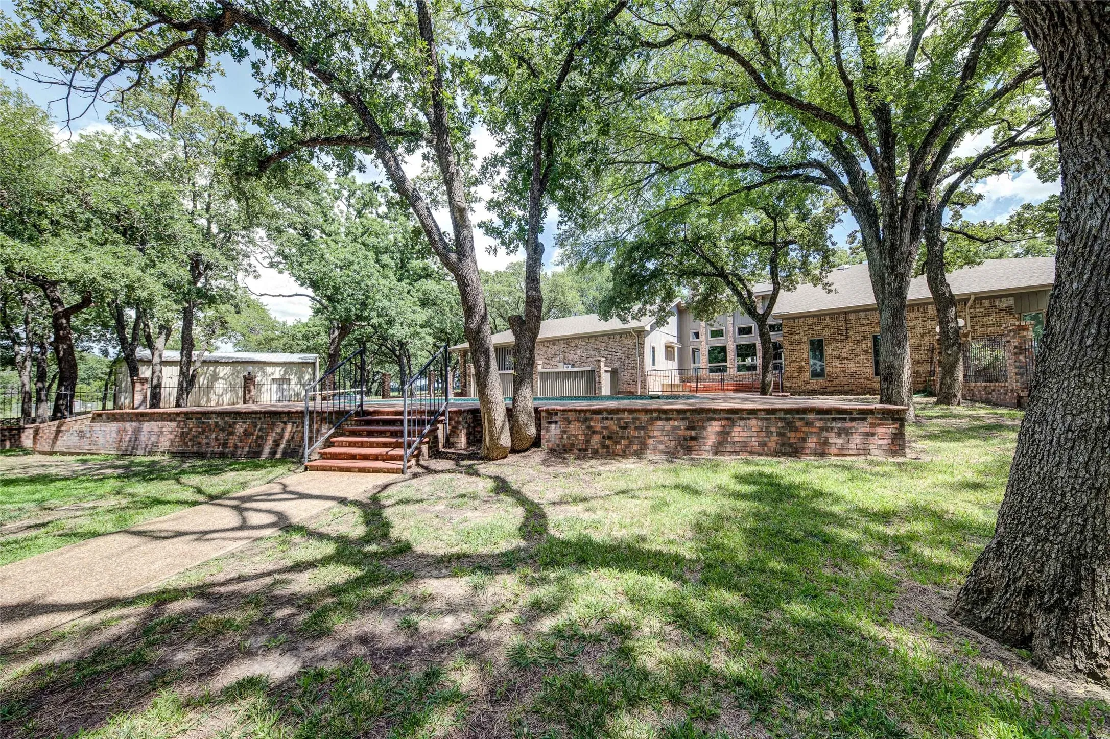View of green lawn with a wooden deck