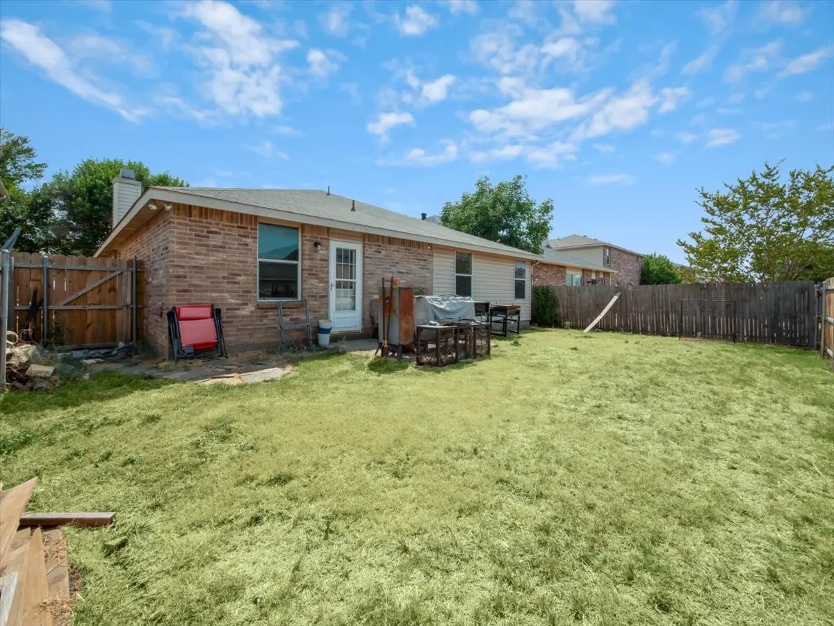 Back of property with a lawn
