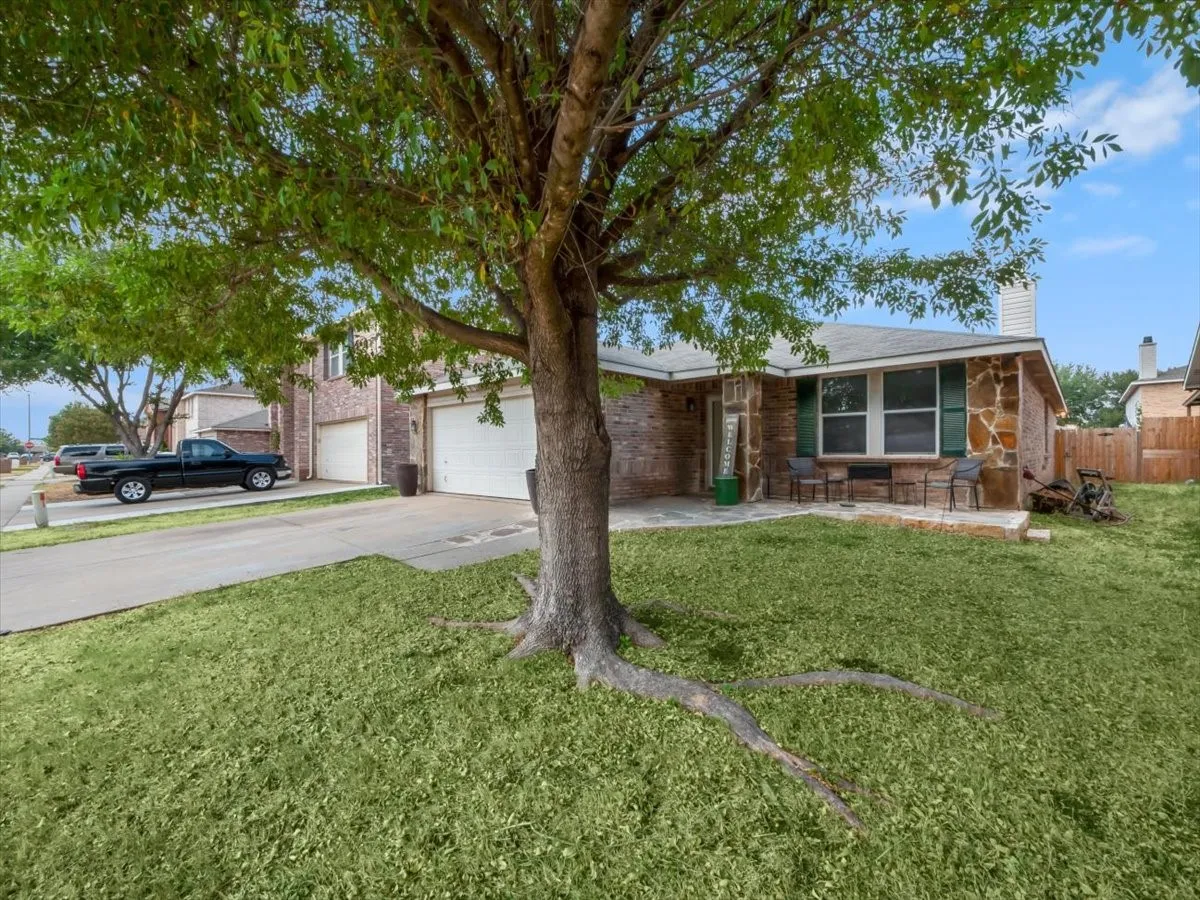Single story home featuring a front lawn