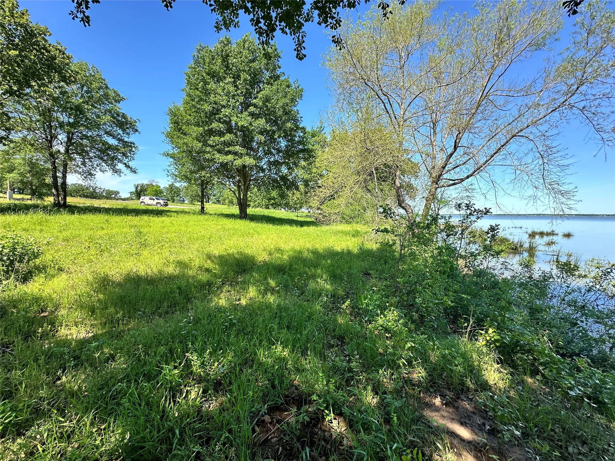 Level waterfront homesite ready for your custom lake home.