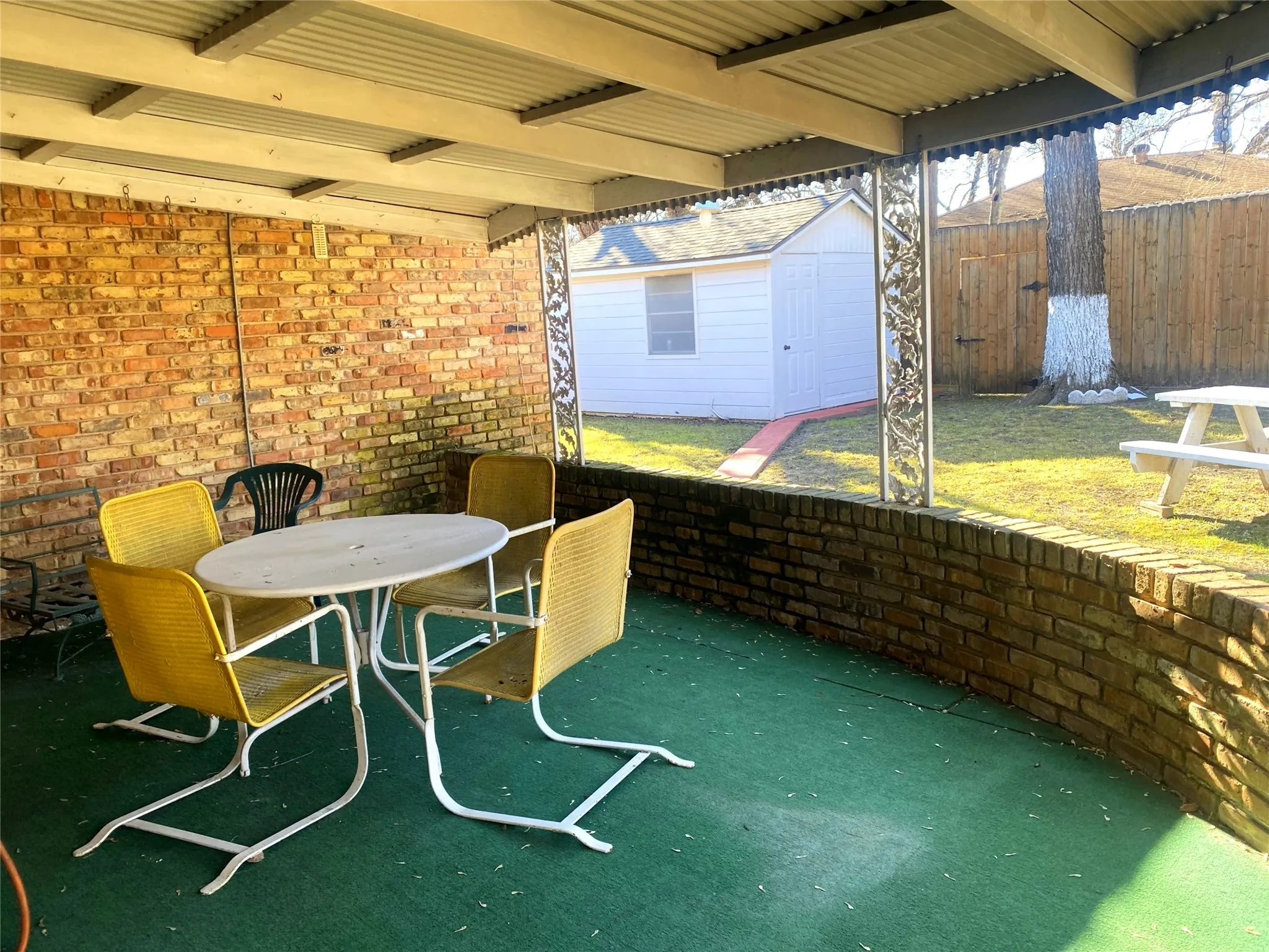 View of patio featuring a shed