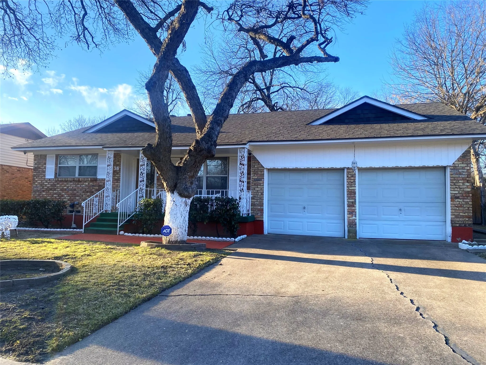 Ranch-style house featuring a front yard and a garage