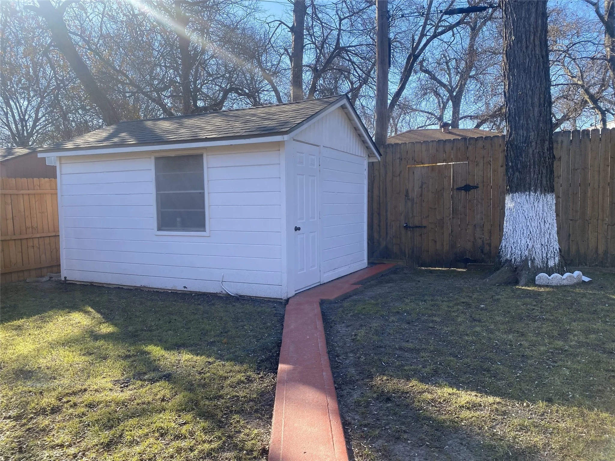 View of outbuilding featuring a lawn