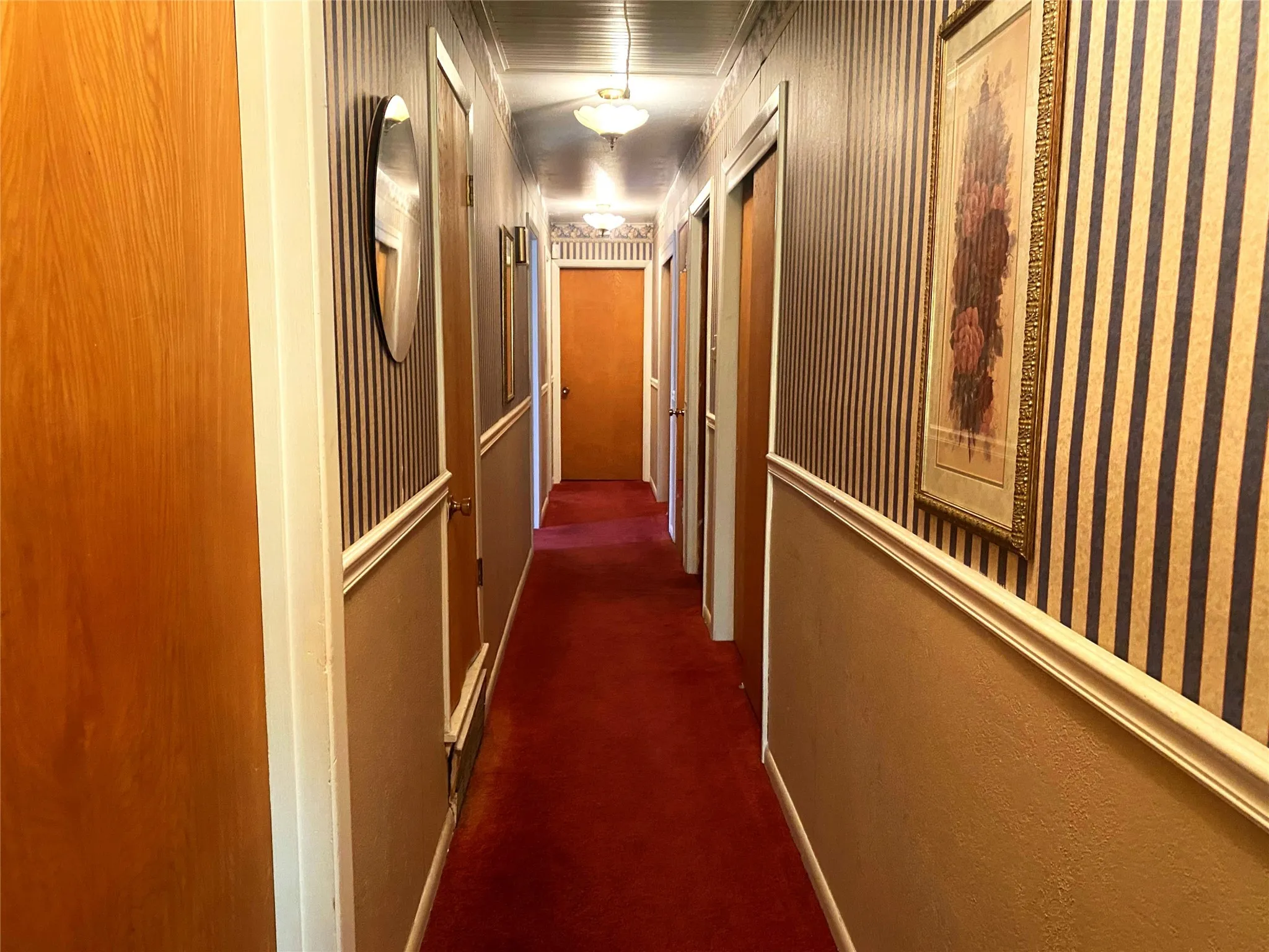 Hall featuring dark carpet and ornamental molding