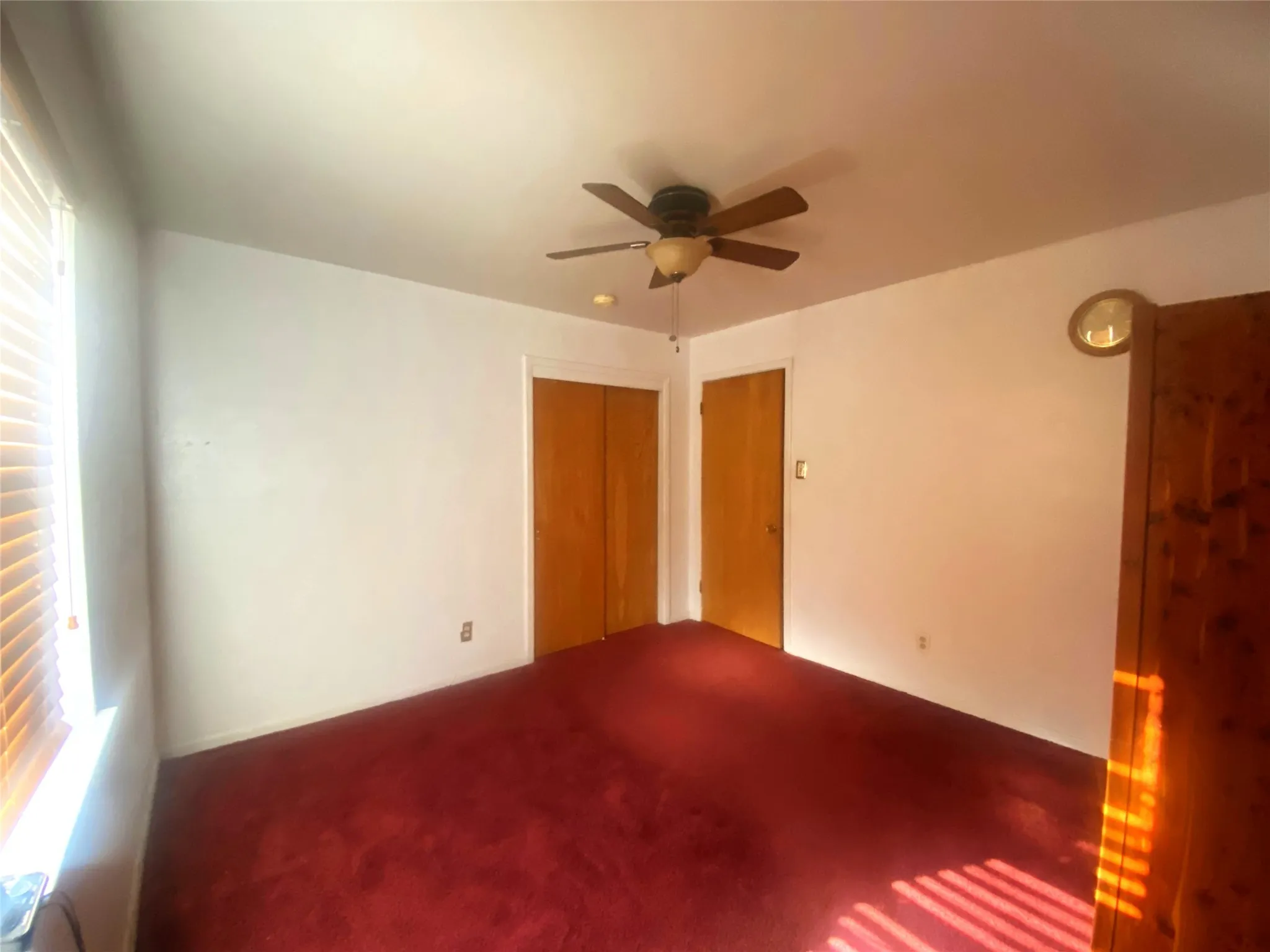 Spare room with carpet floors and ceiling fan