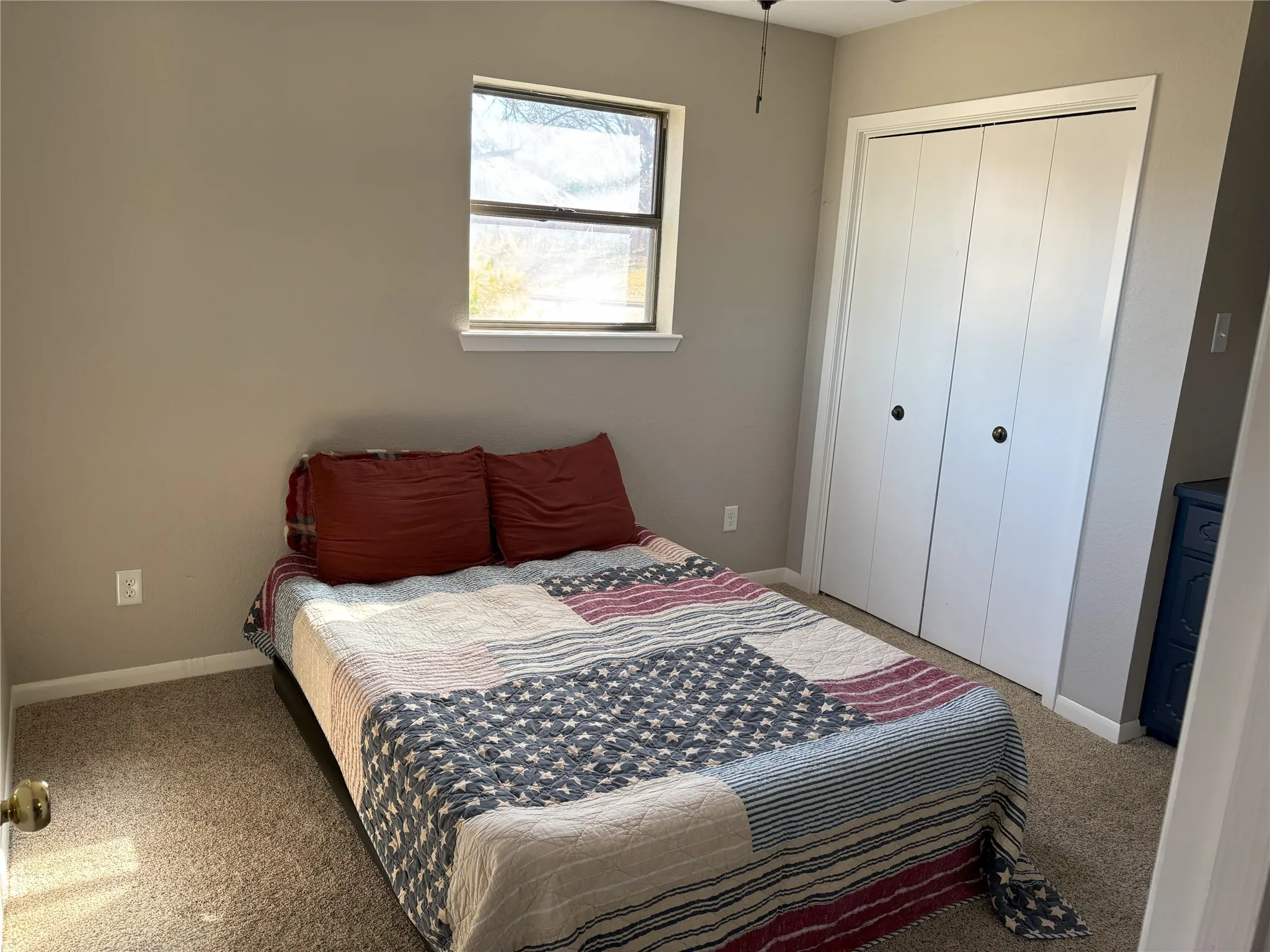 Bedroom featuring carpet flooring and a closet