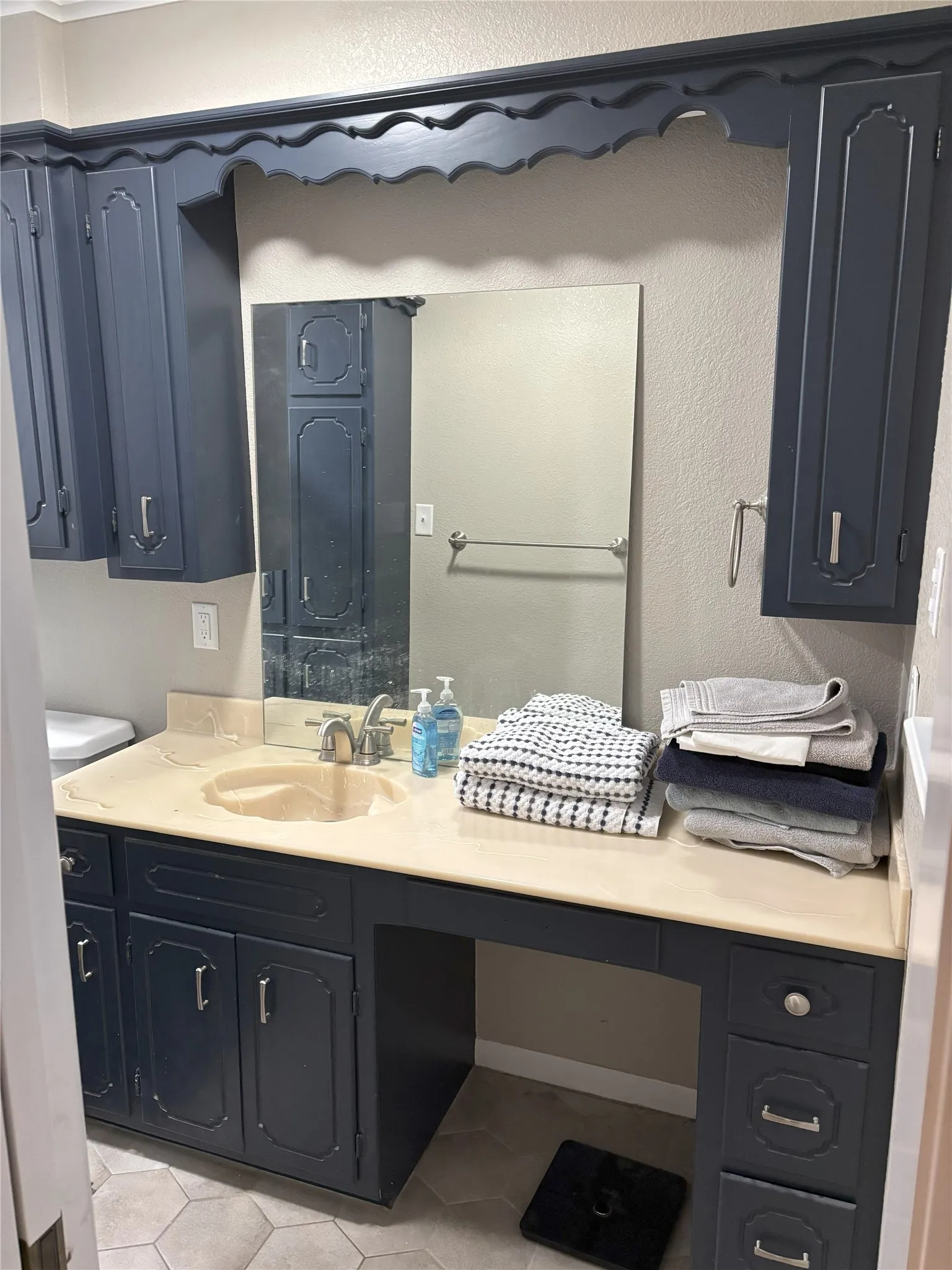 Bathroom featuring tile patterned flooring and vanity