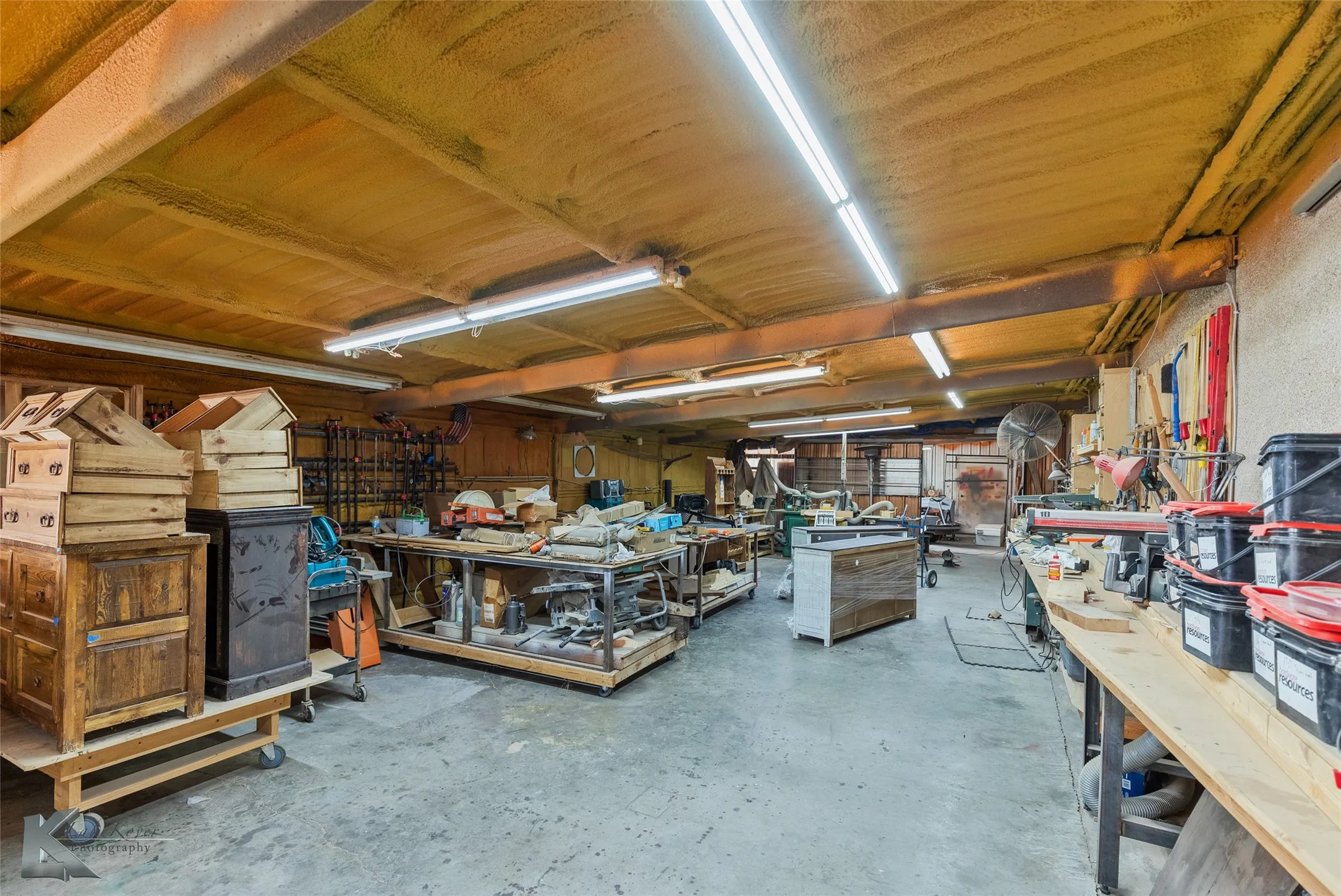 Miscellaneous room with concrete flooring and a workshop area