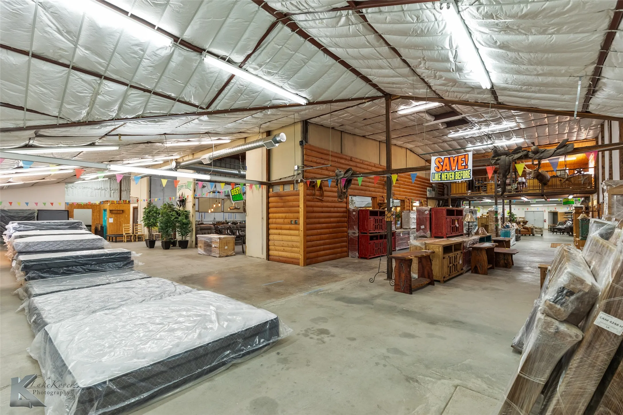 Misc room featuring concrete flooring and vaulted ceiling