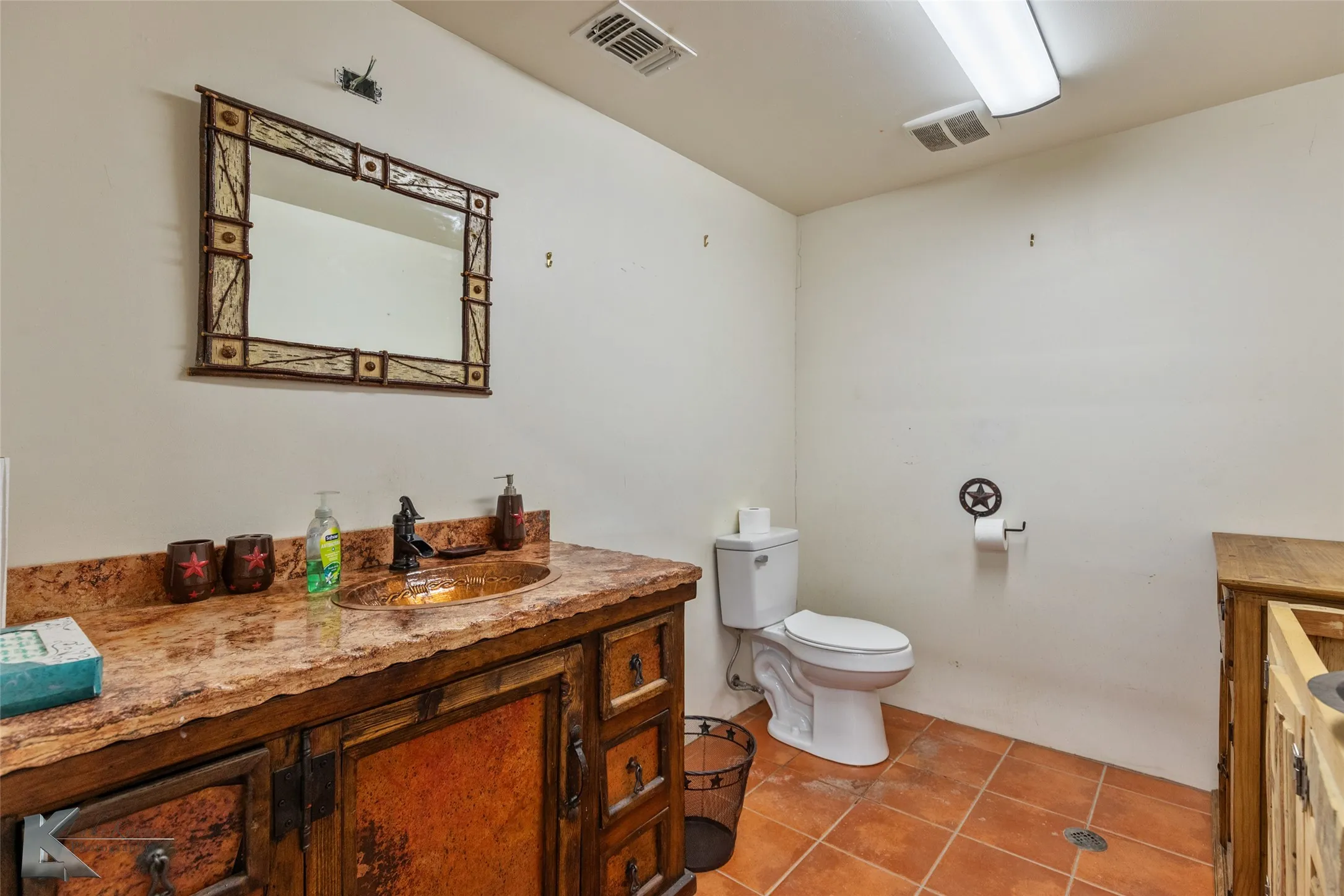 Bathroom with tile patterned flooring, vanity, and toilet