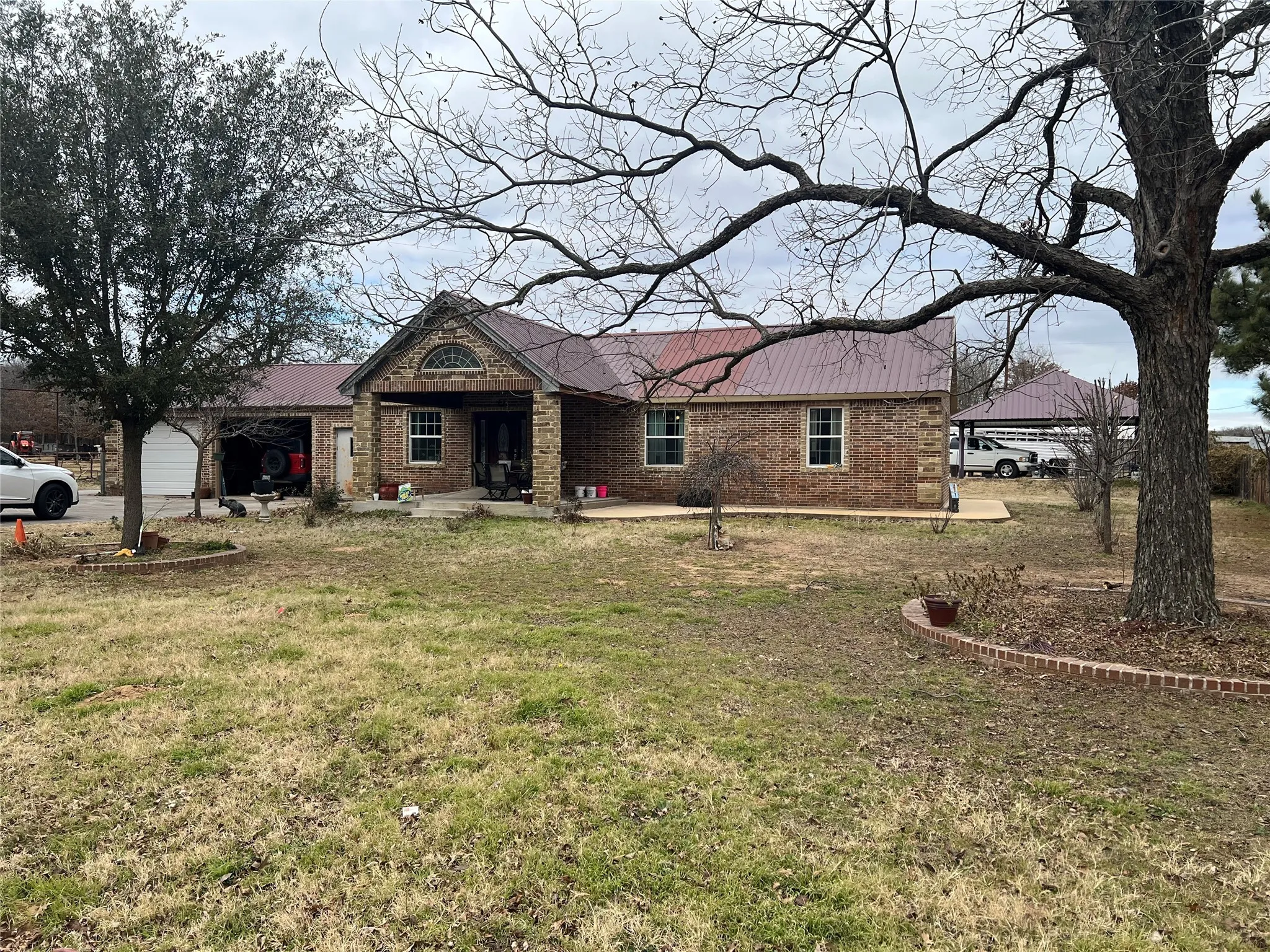 View of front of home with a garage and a front yard
