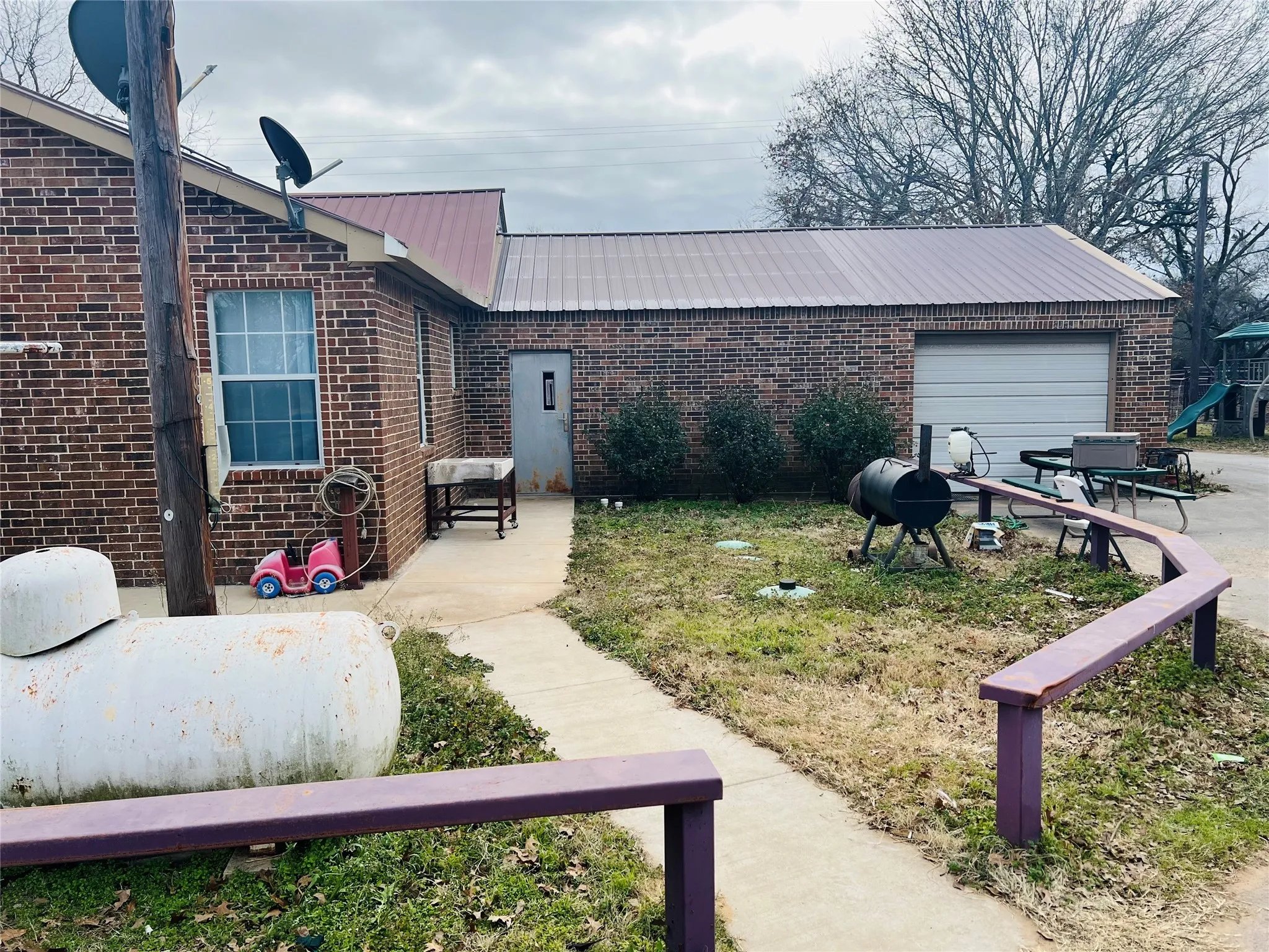 View of front of property with a garage and a patio