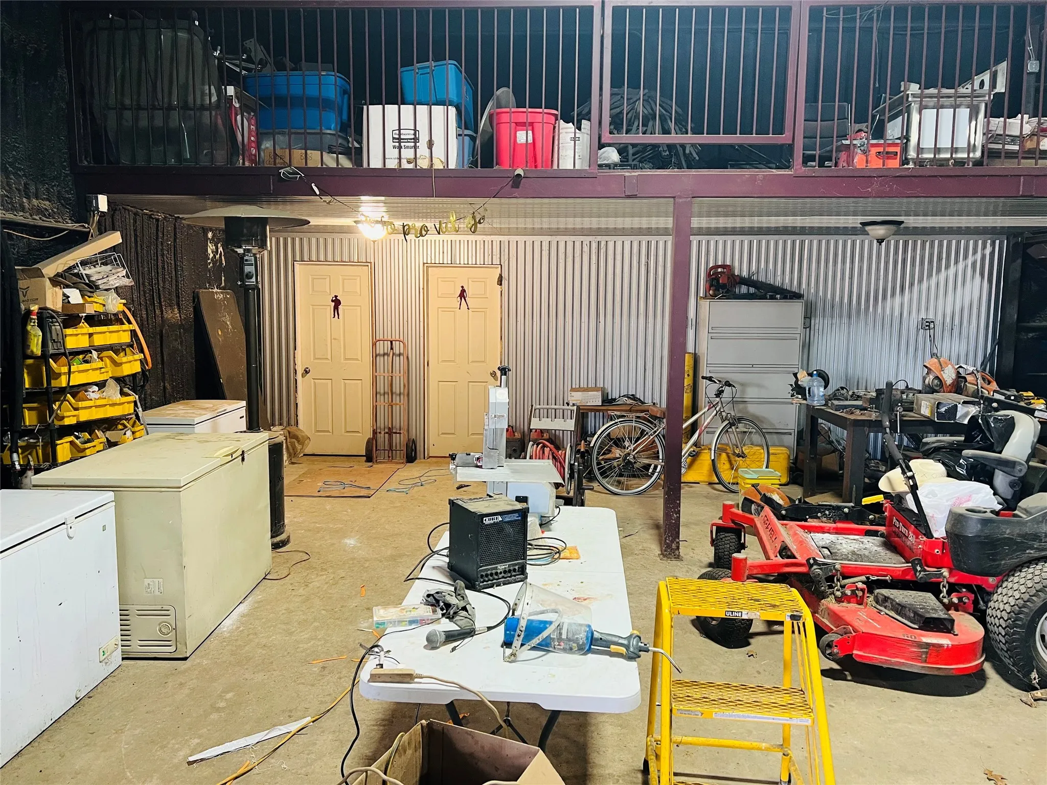 Garage featuring refrigerator and a workshop area
