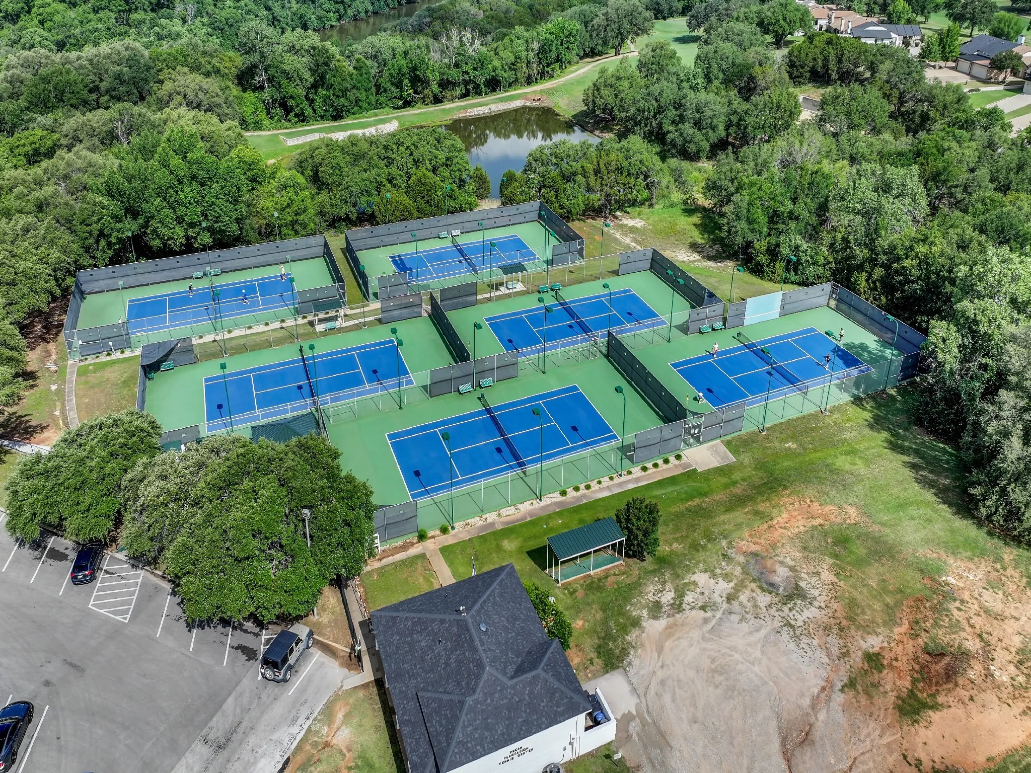 Drone / aerial view of a large body of water and a heavily wooded area