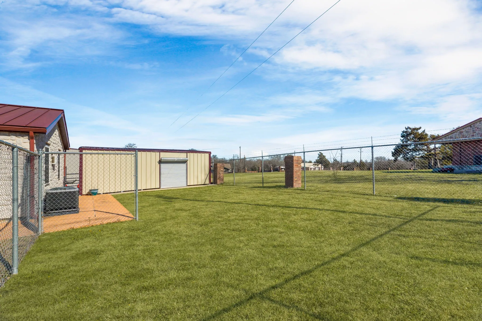 View of yard featuring a carport, yard for gatherings, and central air condition unit