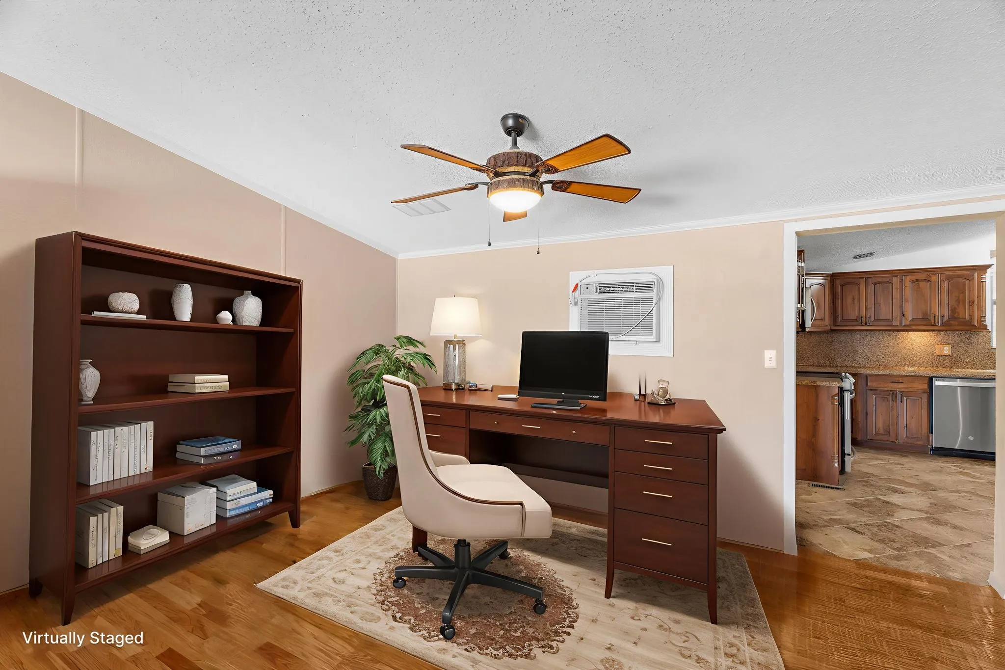 Office with ceiling fan and hand scraped wood flooring