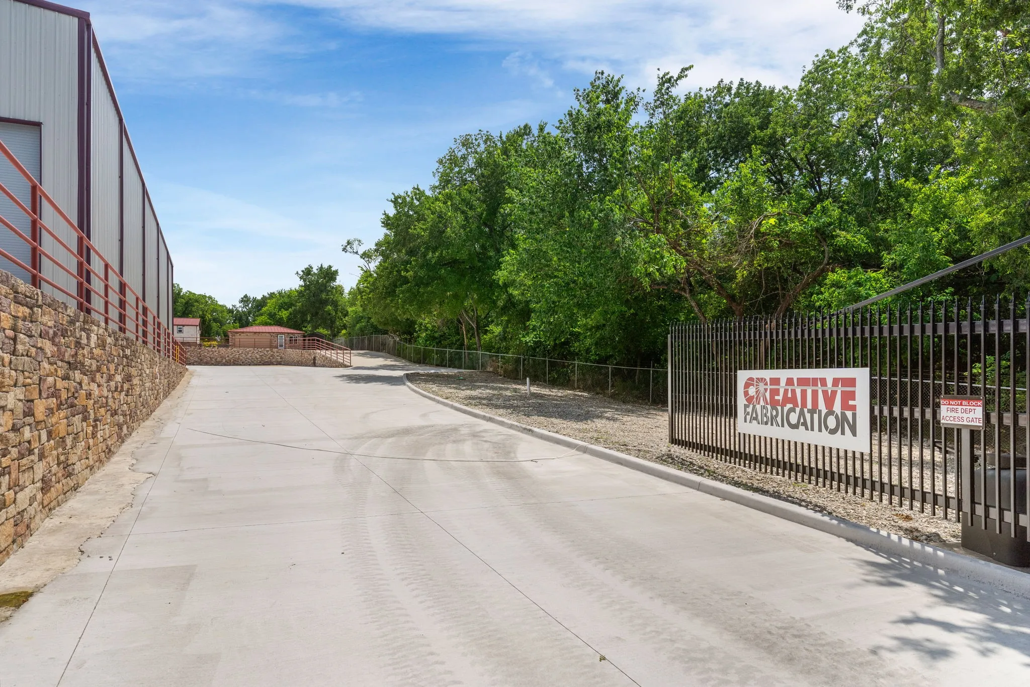 View of concrete entry with a curb and electric gate