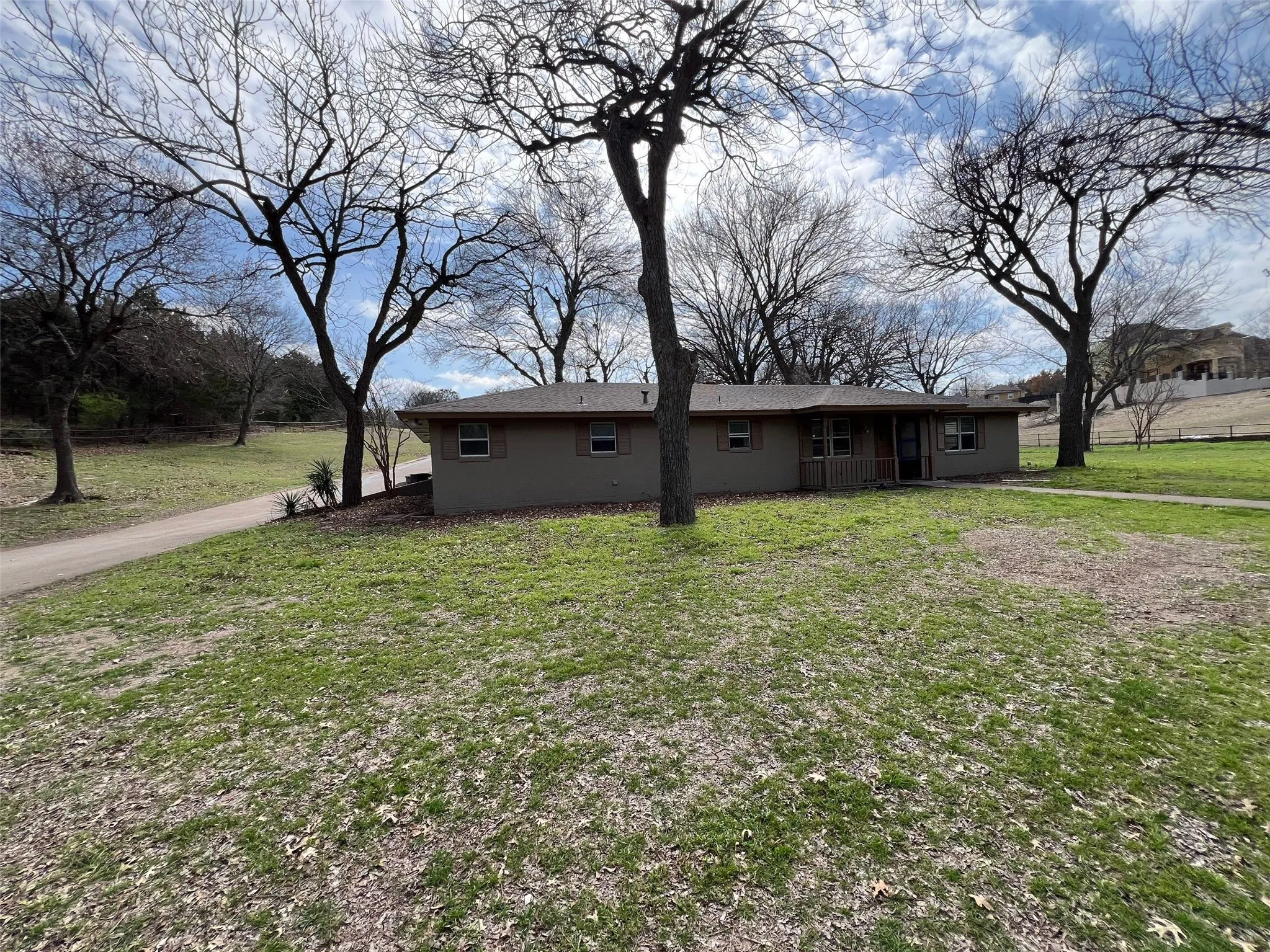 Back of property featuring a lawn