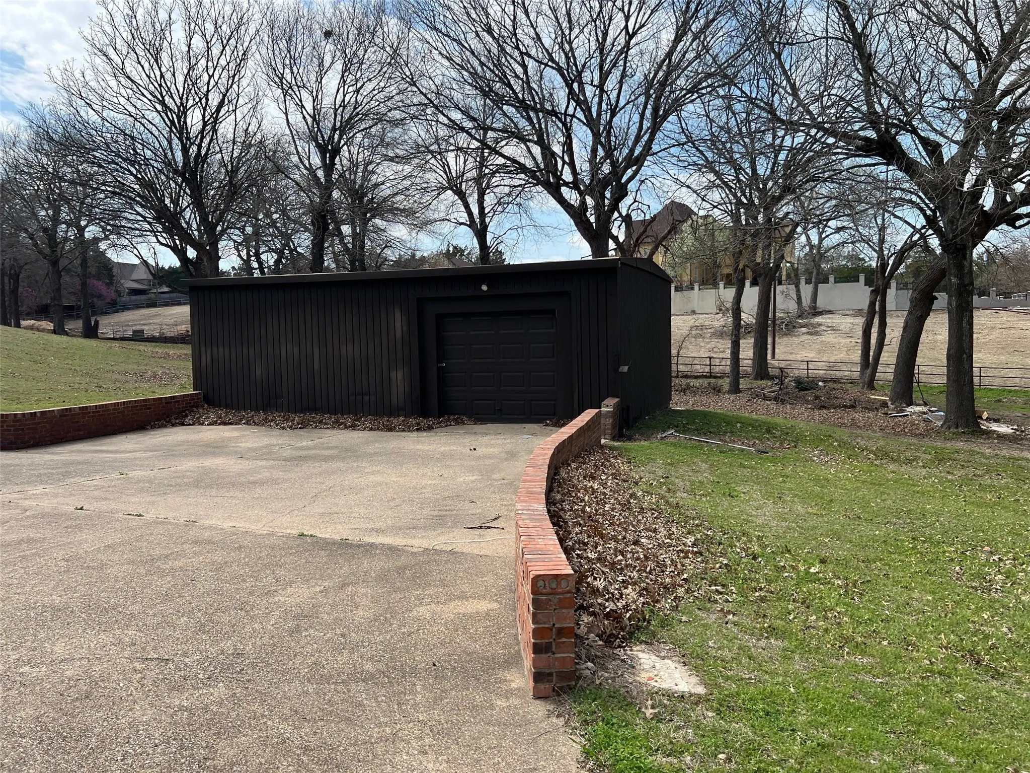 View of outbuilding with a yard and a garage
