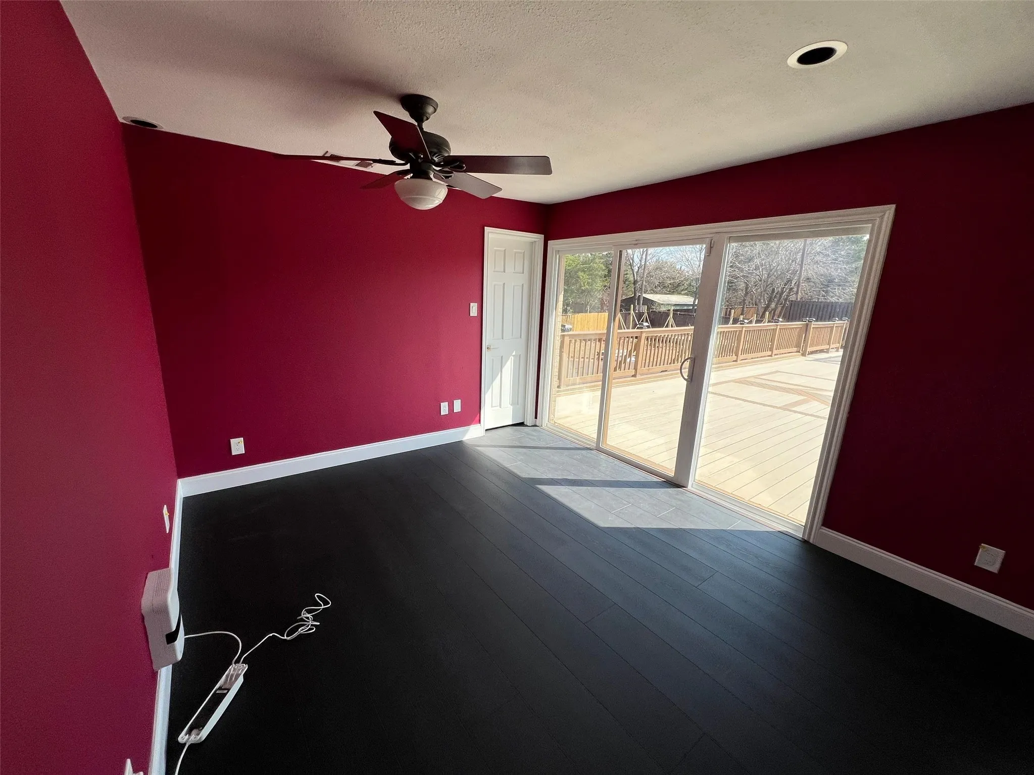 Spare room featuring wood-type flooring and ceiling fan