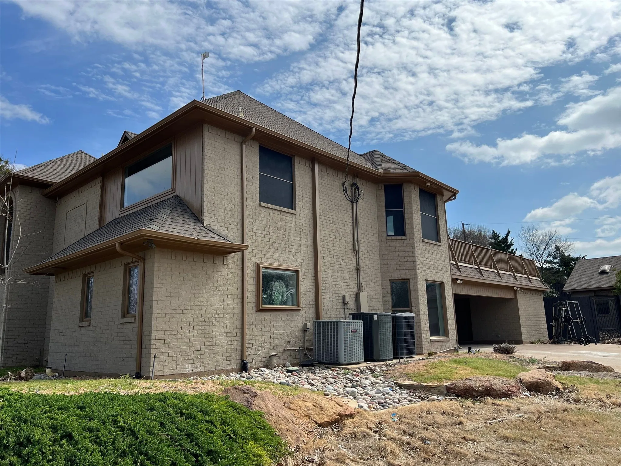 View of side of home with central AC unit