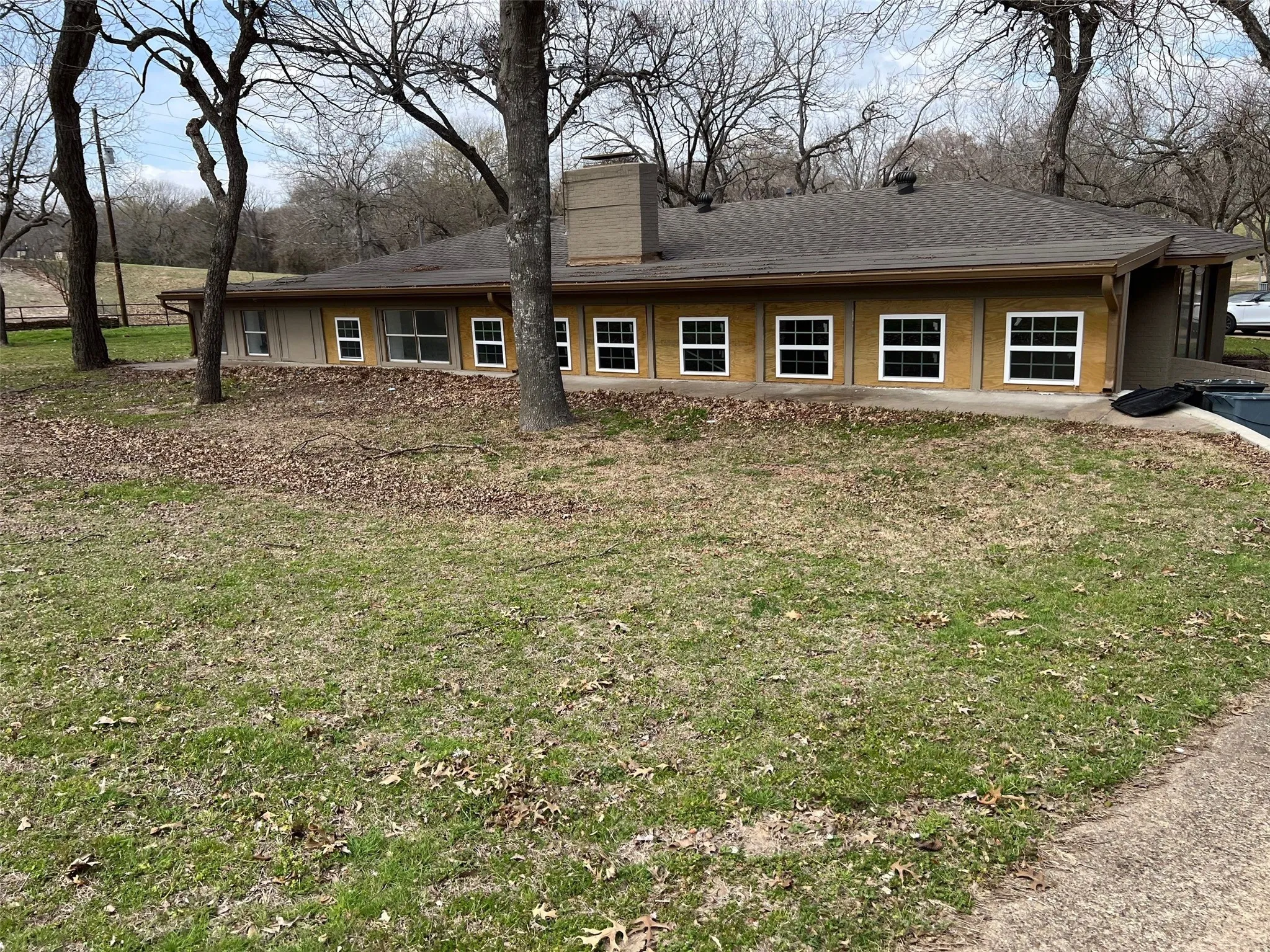 Back of house featuring a lawn