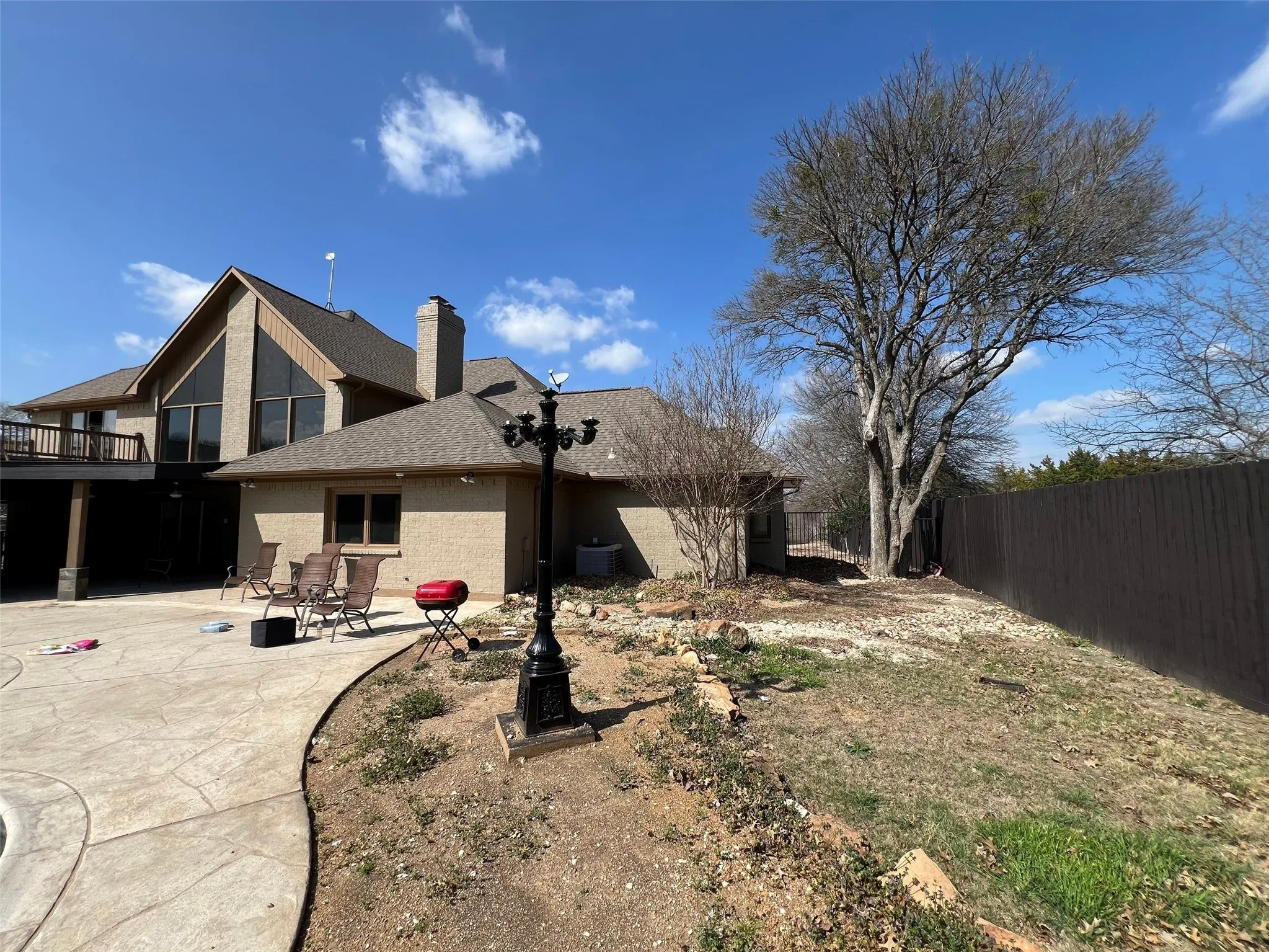 Rear view of house featuring cooling unit and a patio area