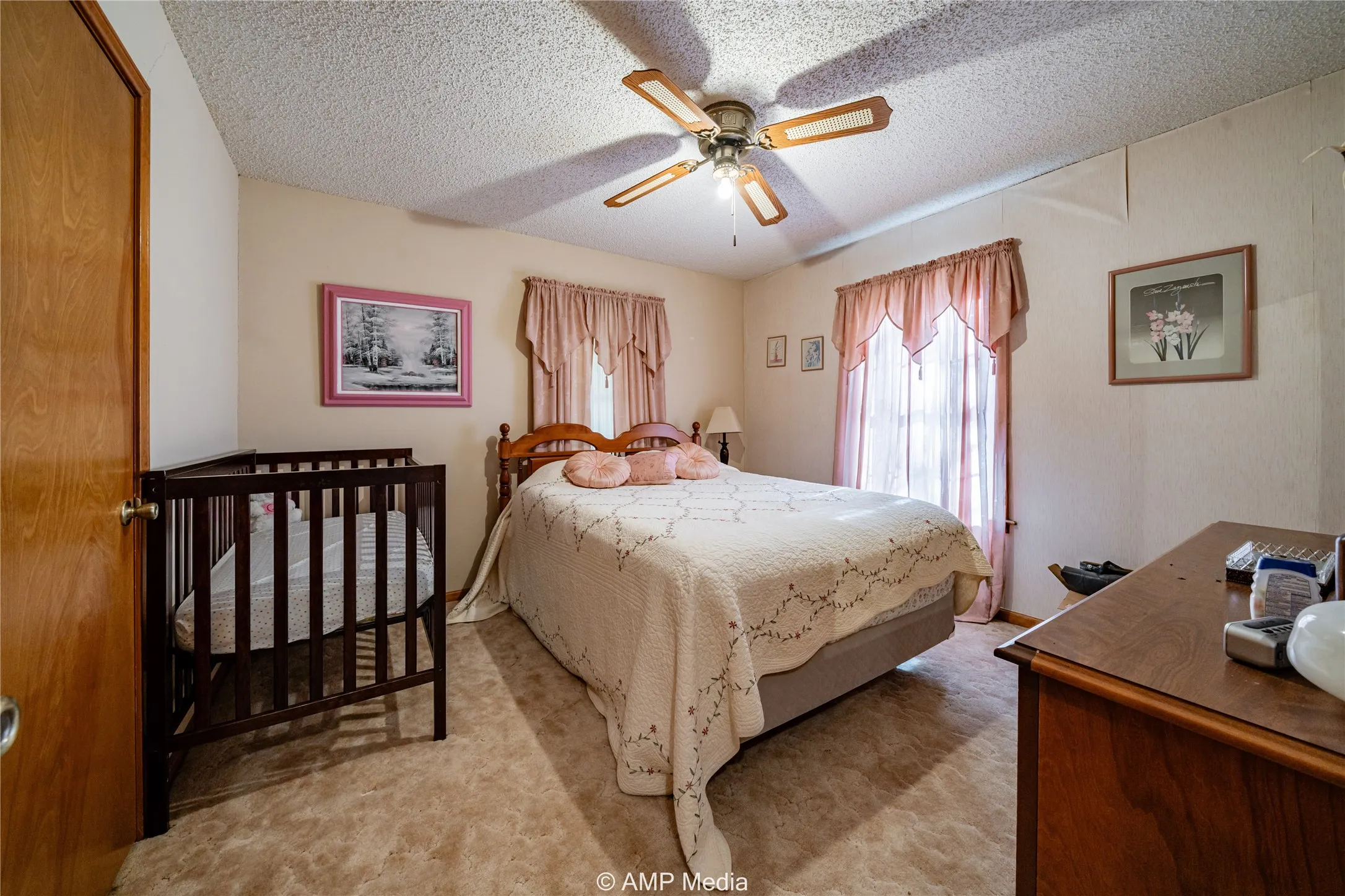 Bedroom featuring ceiling fan, light carpet, and a textured ceiling