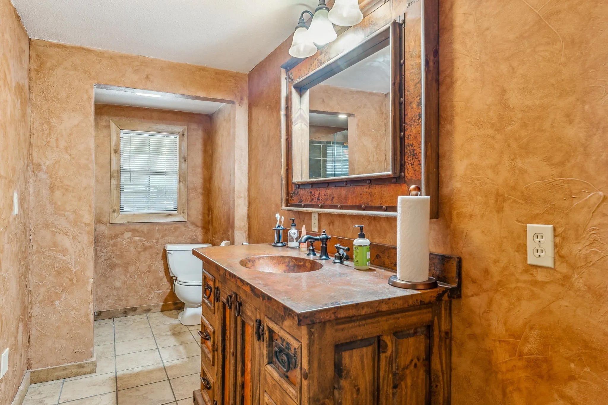 Bathroom with toilet, tile patterned flooring, baseboards, and vanity