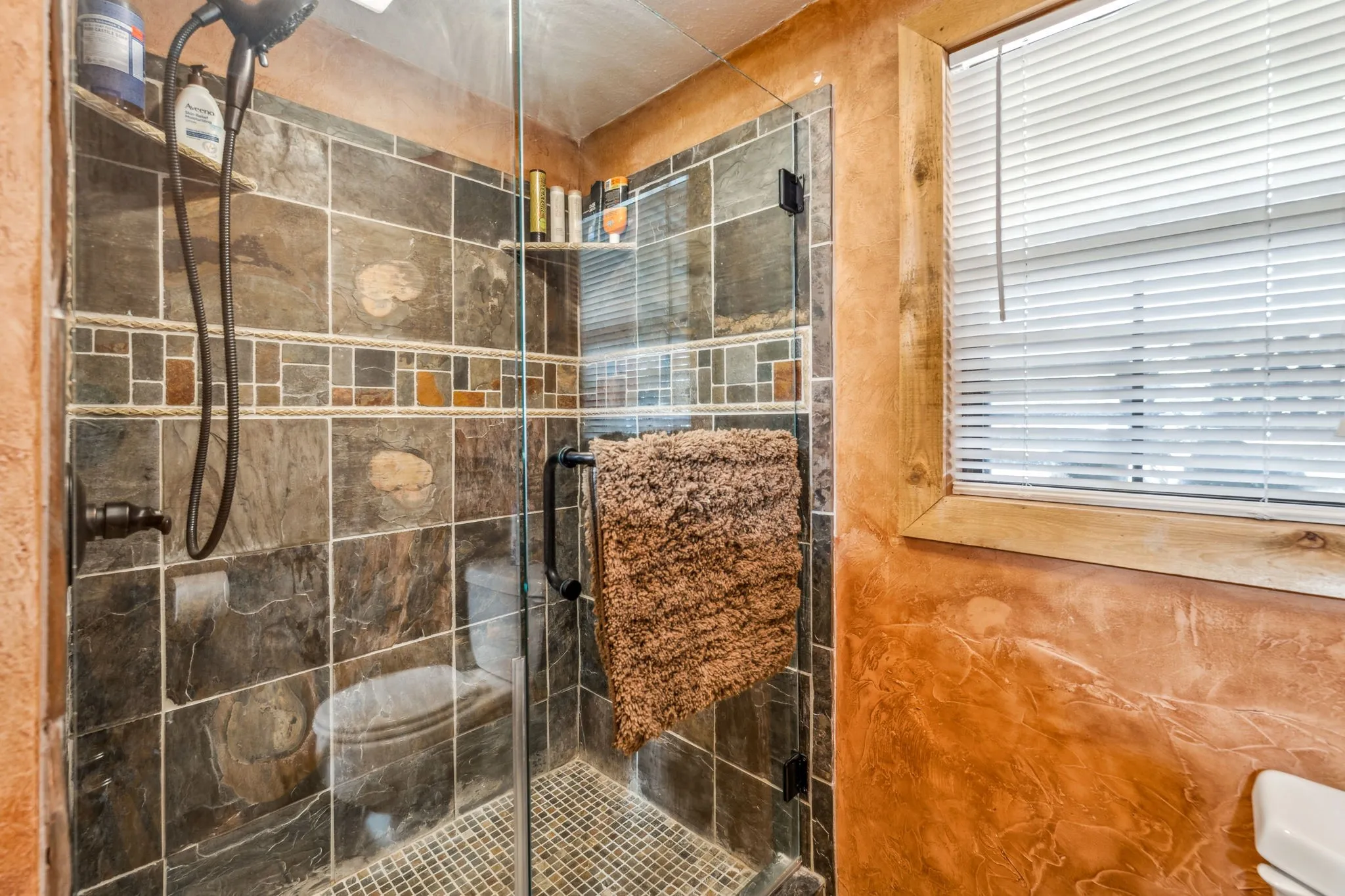 Full bathroom with a shower stall and toilet