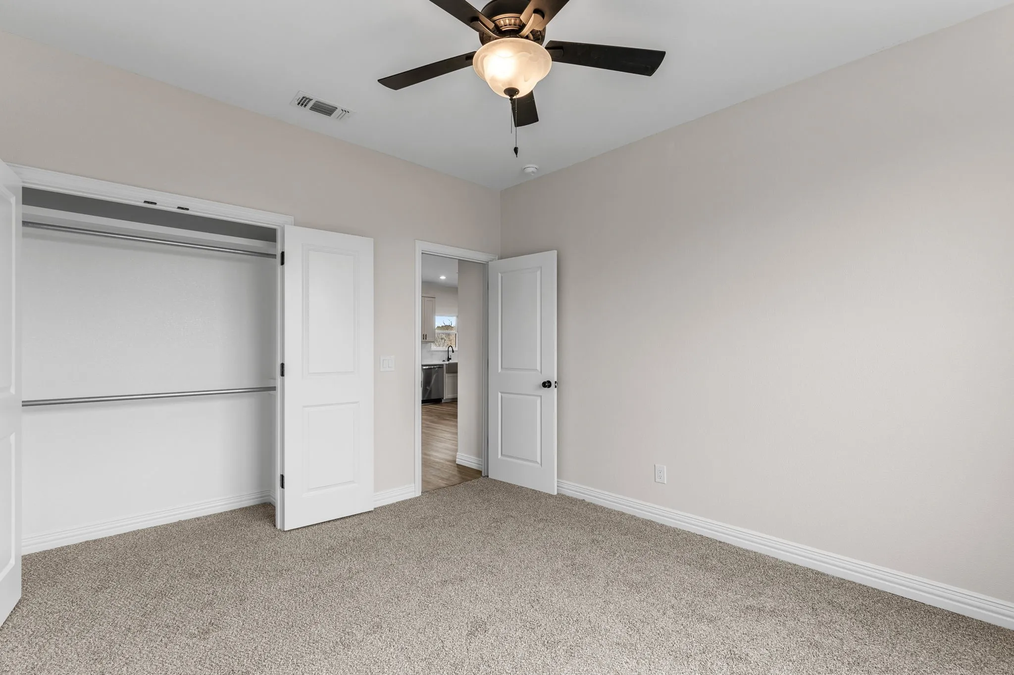Unfurnished bedroom featuring ceiling fan, a closet, and​​‌​​​​‌​​‌‌​‌‌​​​‌‌​‌​‌​‌​​​‌​​ carpet