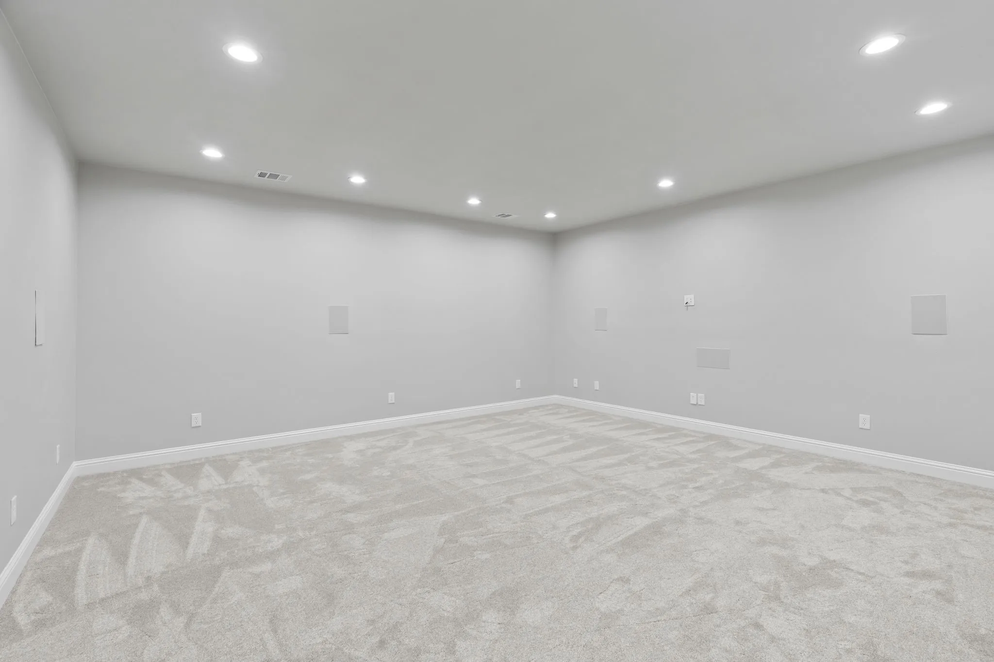 Empty room with light colored carpet