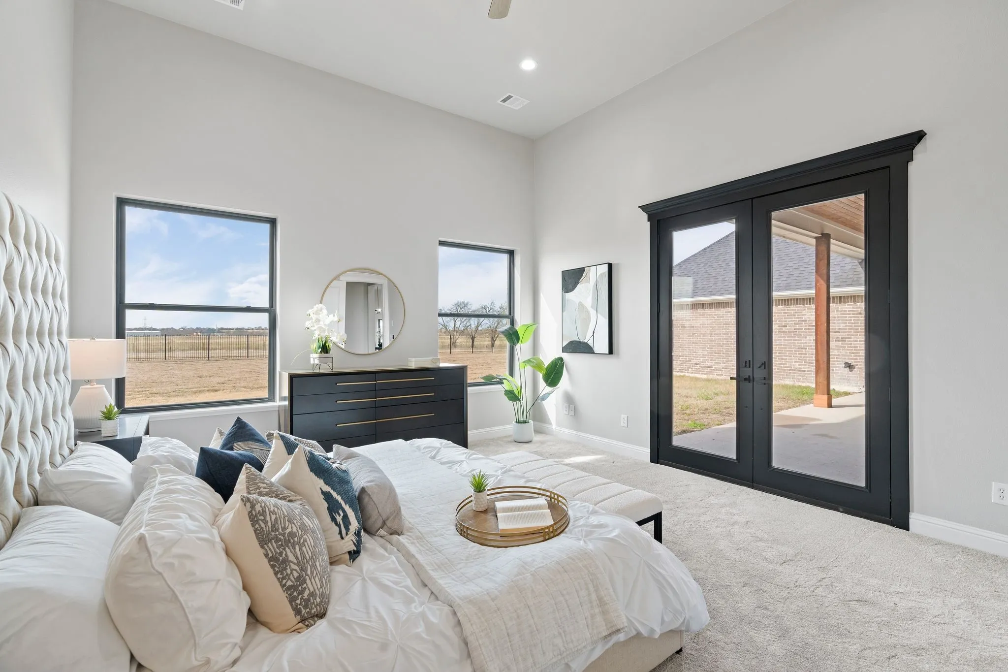 Carpeted bedroom featuring access to exterior and french doors