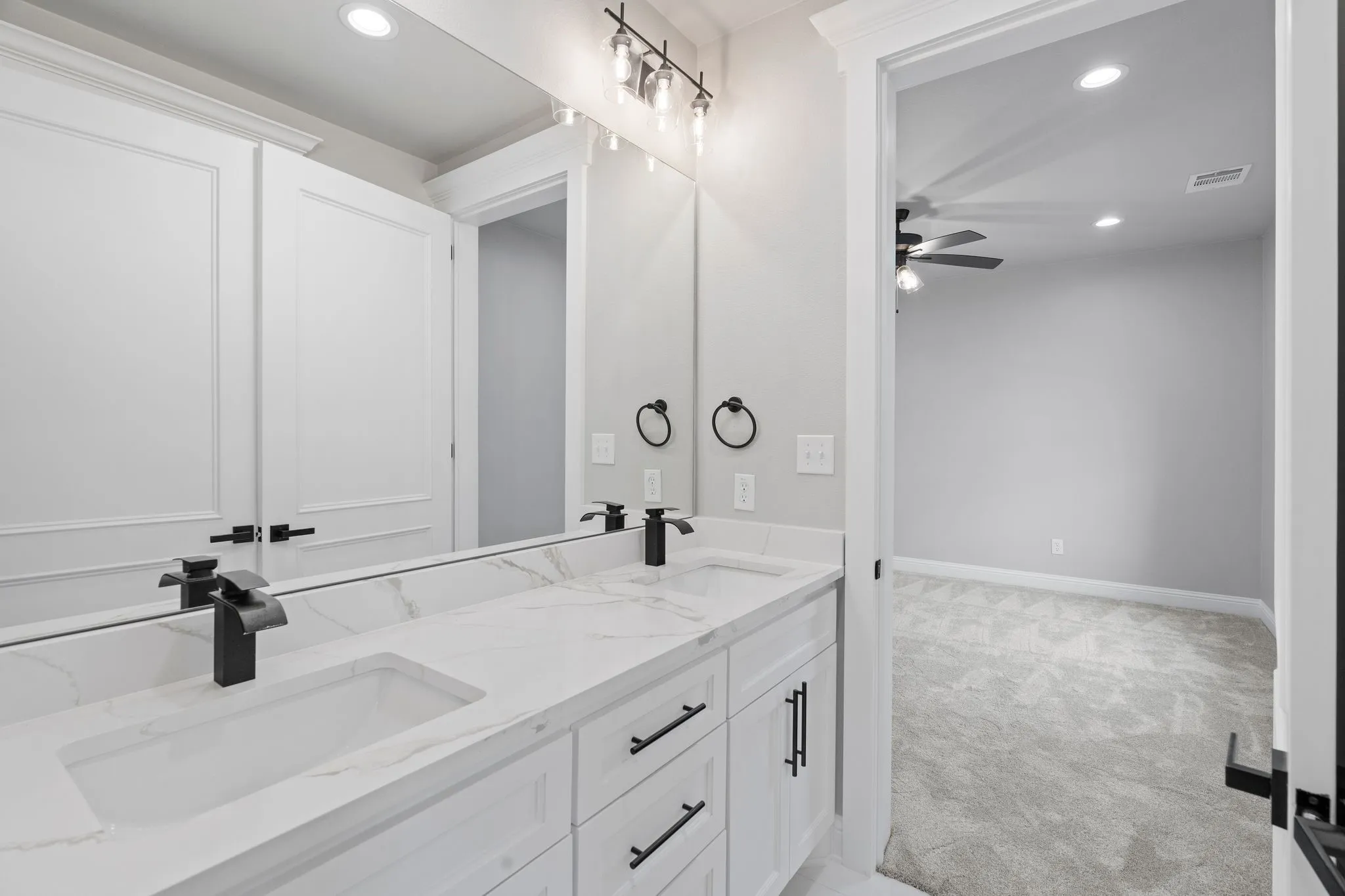 Bathroom with ceiling fan and vanity