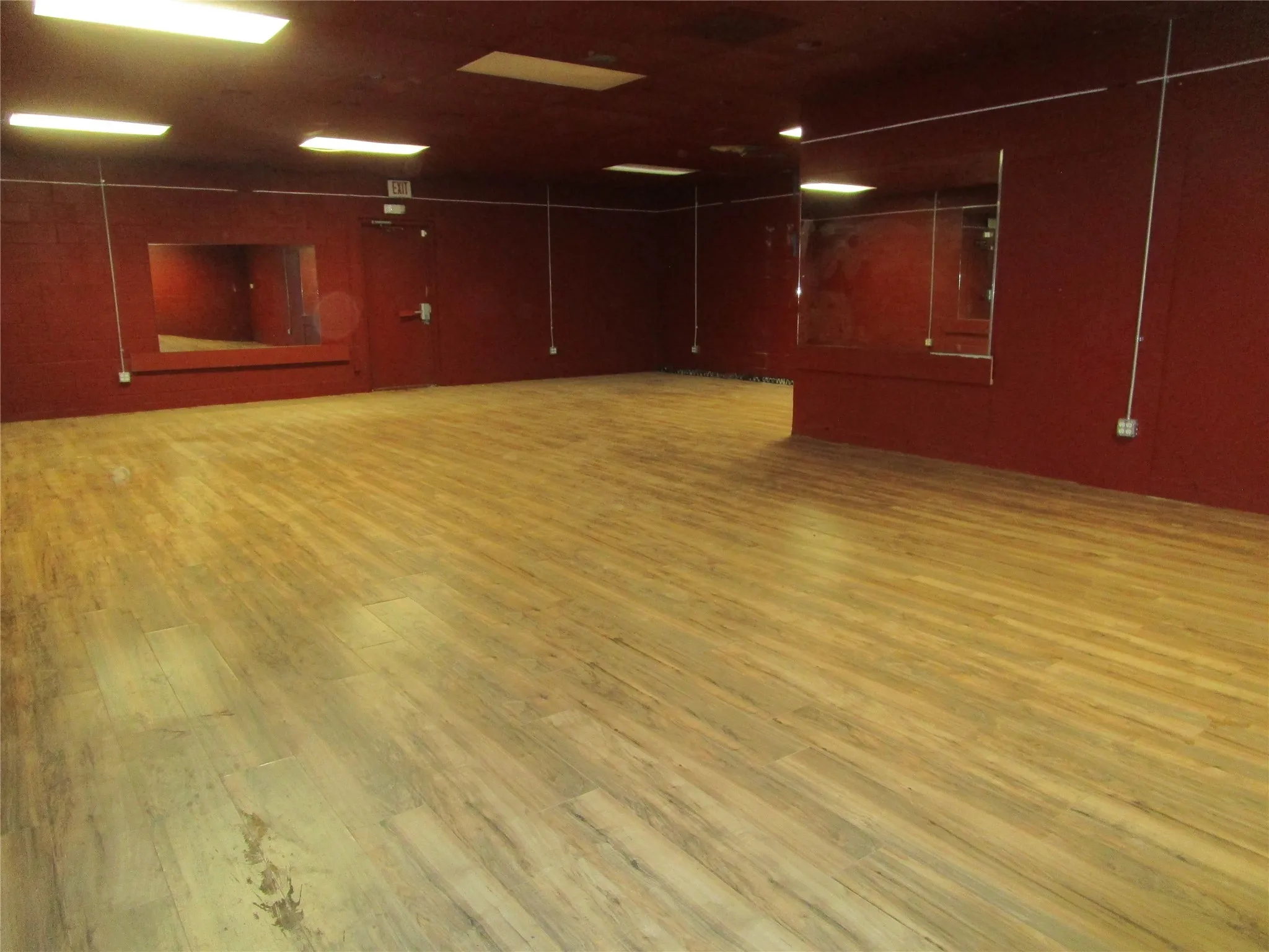 Empty room with light hardwood / wood-style flooring