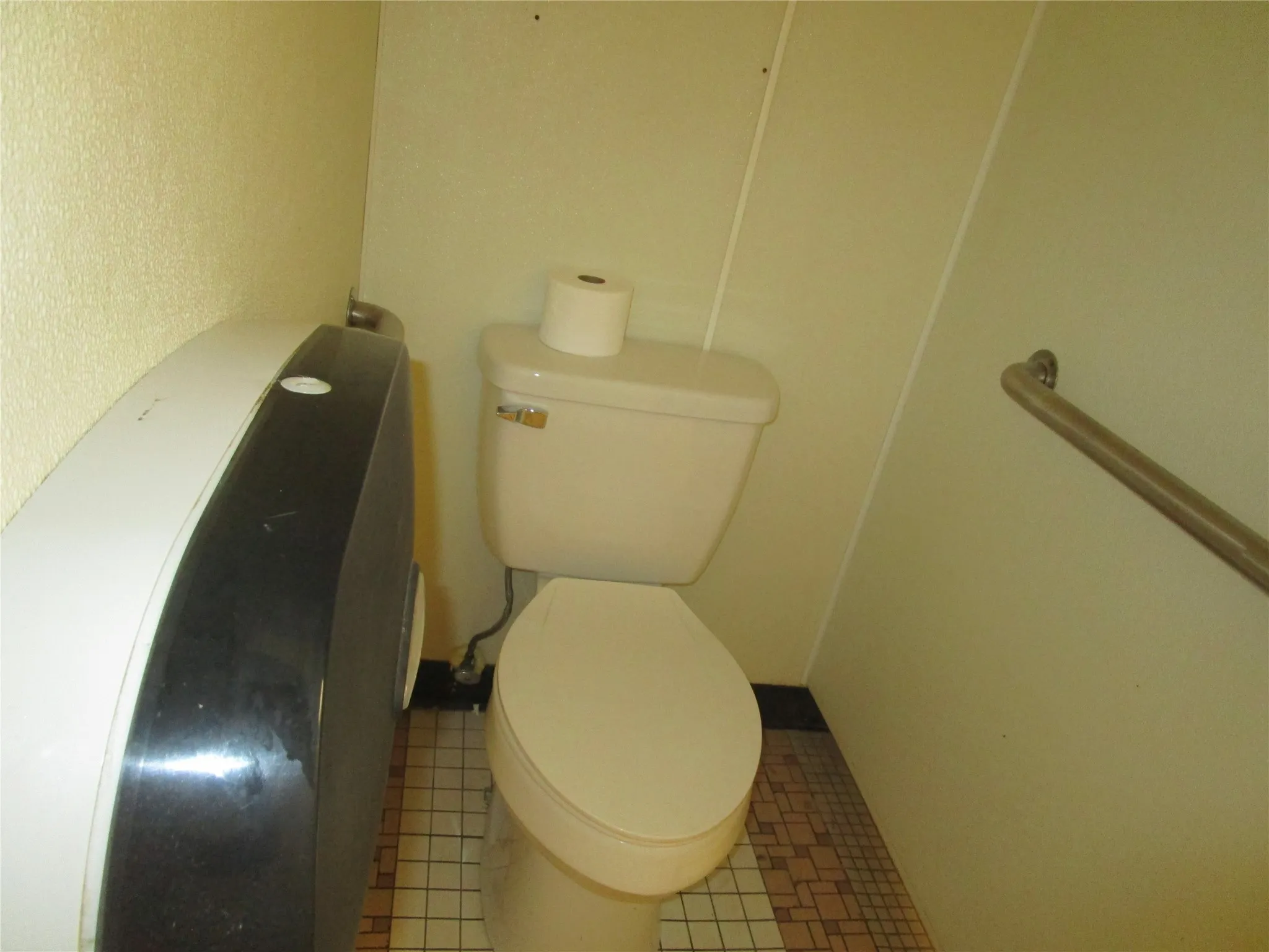 Bathroom featuring tile patterned flooring and toilet