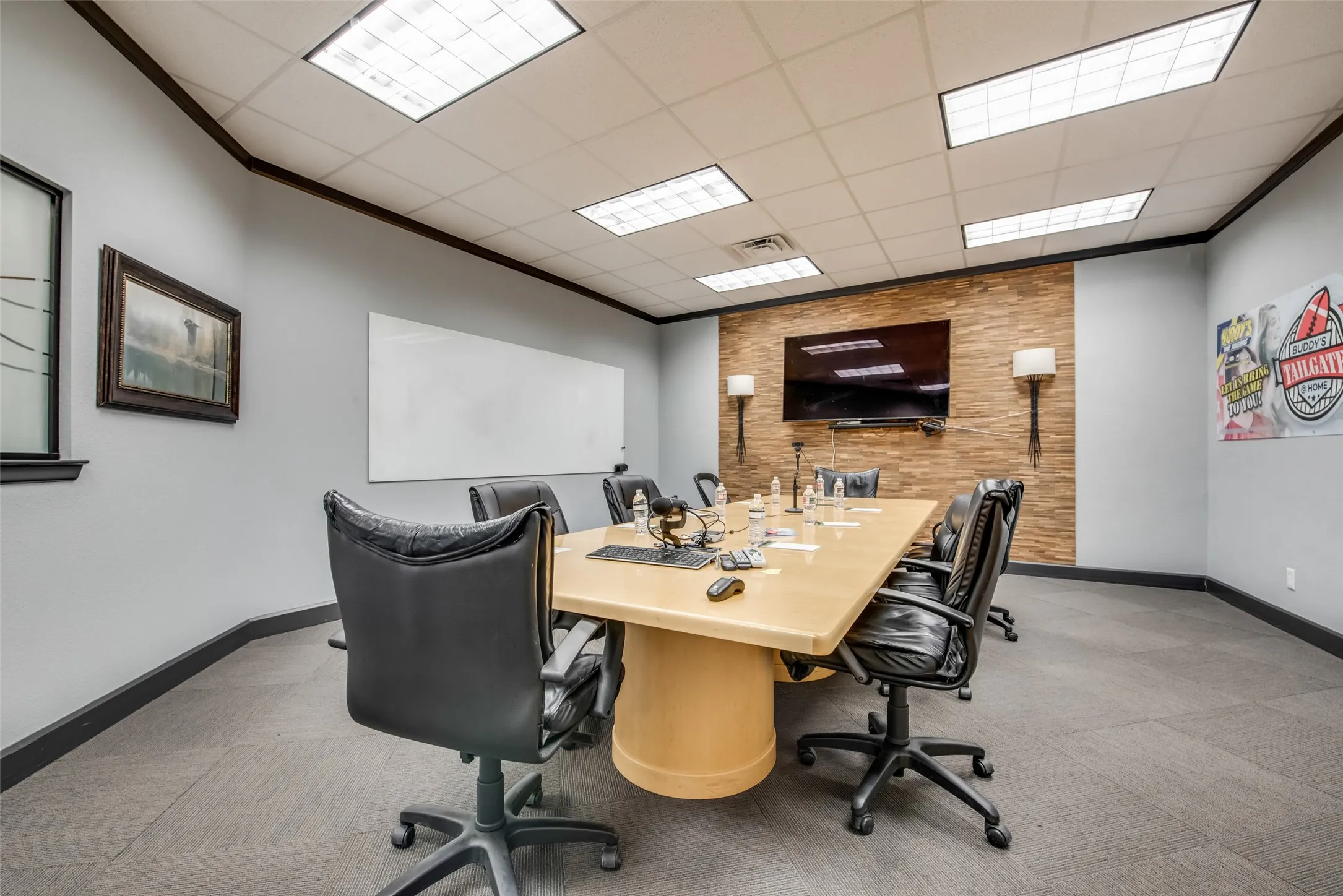 Office space with crown molding, a paneled ceiling, and wood walls