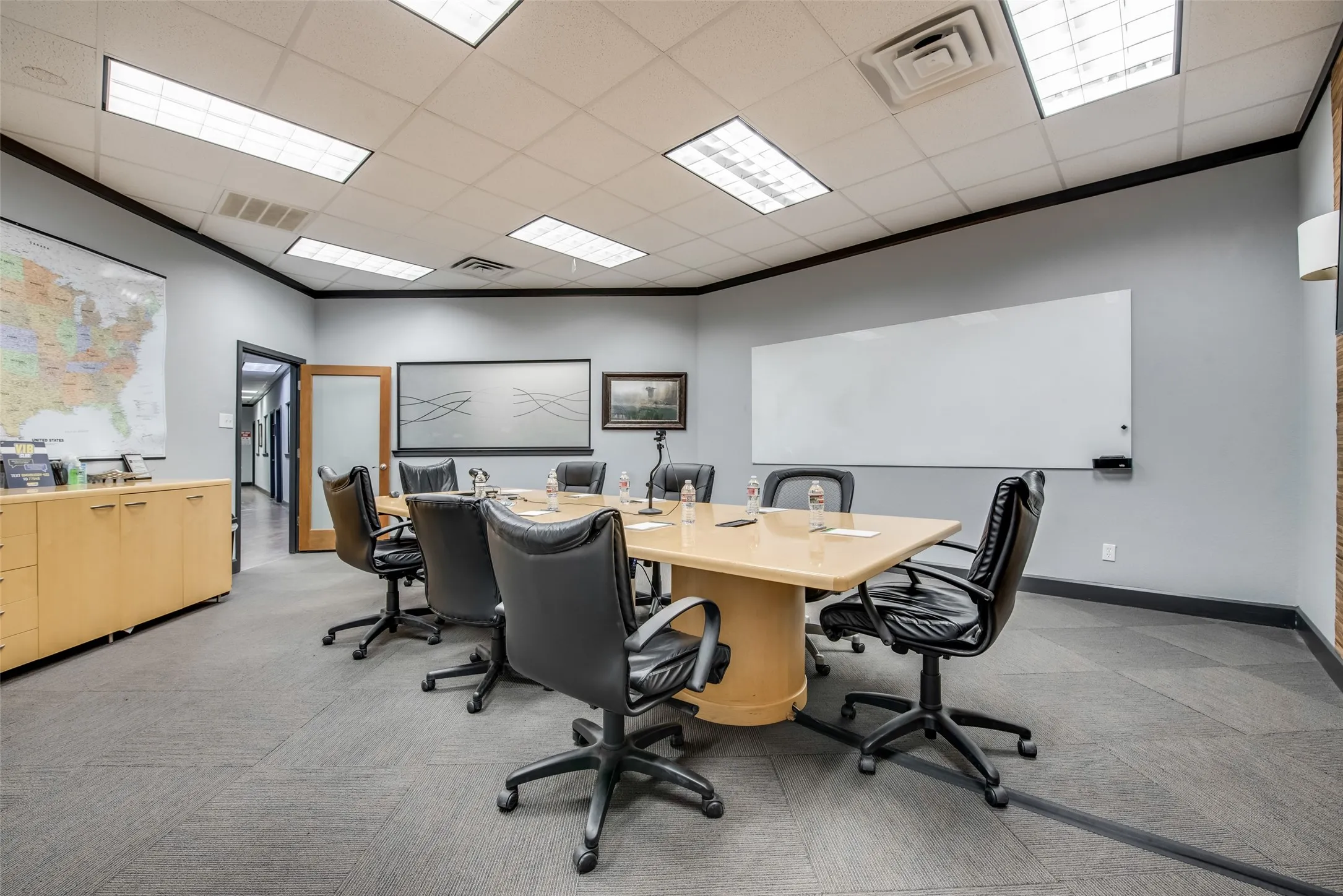 Office area featuring ornamental molding, a paneled ceiling, and light carpet