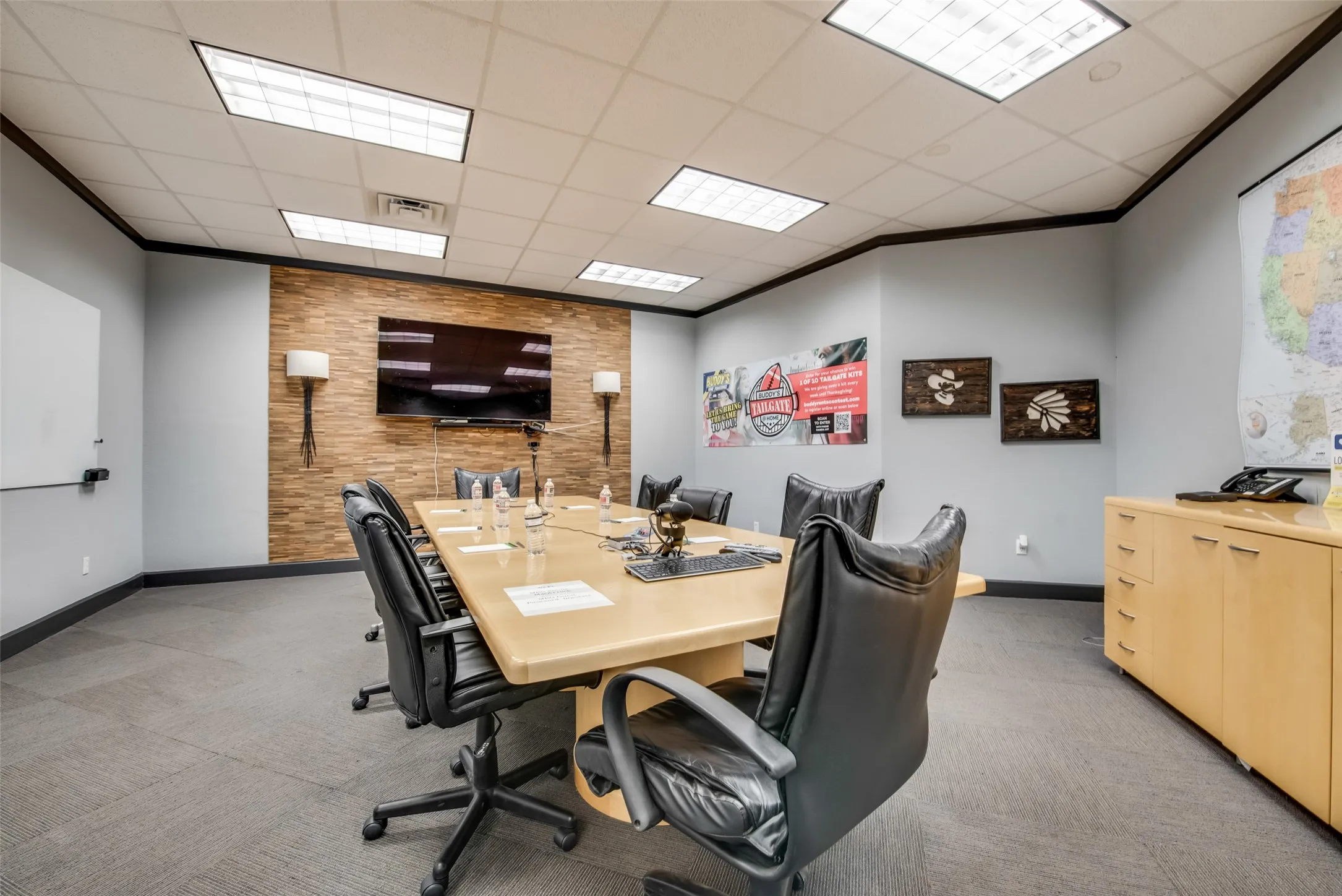 Office space with crown molding, a paneled ceiling, and light carpet
