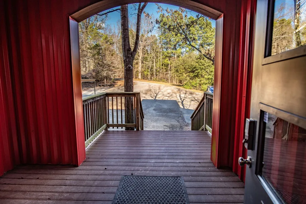 View of wooden entry to modern style offices in back